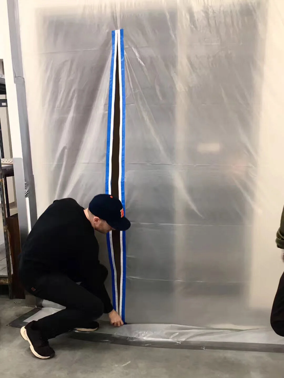 Michael Edward Miller Critical Space Item , 2018, dyed slip cast fired clay powder, laser cut coloured plexiglass, plastic catering container, authentic NASA critical space item label, altered authentic NASA non-disclosure agreements, respiratory masks, hypoallergenic gloves, stainless steel tables, plastic quarantine sheets, actors, participants