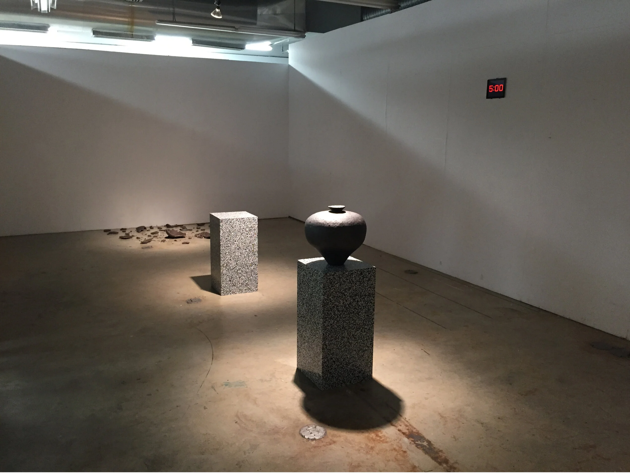 Michael Edward Miller Level One: Agency (prototype) , 2017, hand-coiled reduction fired storage jars with granite feldspar, large smokey quartz crystals, patterned vinyl, MDF plinths, digital timer, sound, light, players