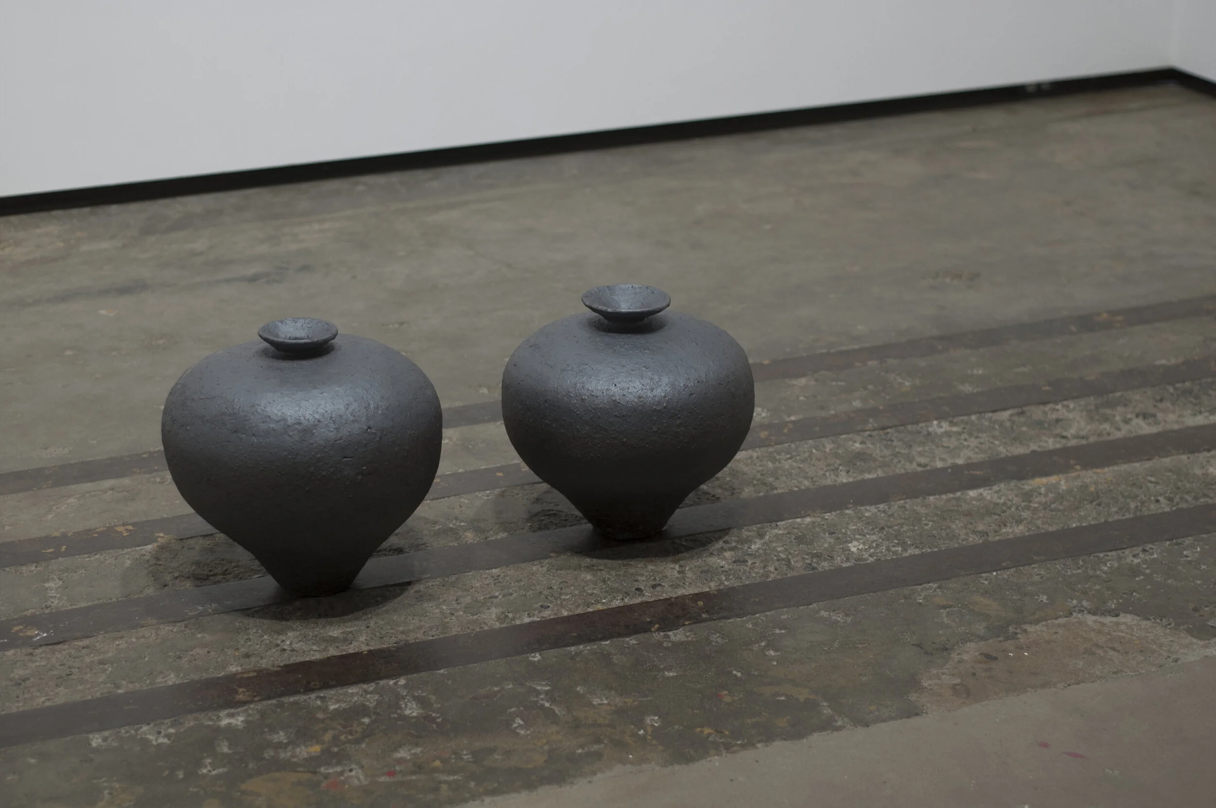 Michael Edward Miller Fracture , 2016, hand-coiled reduction fired storage jars, granite feldspar, black smokey quartz crystal