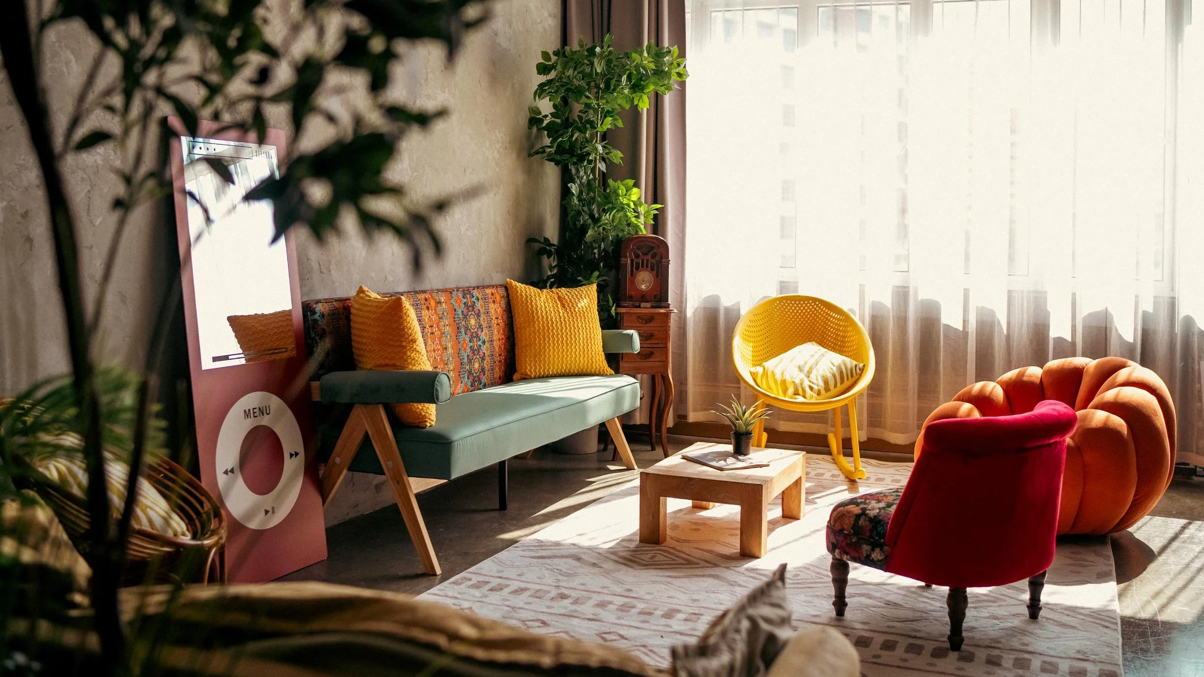 Bohemian inspired lounging area. Furniture can be shifted to make use of the cement textured wall 