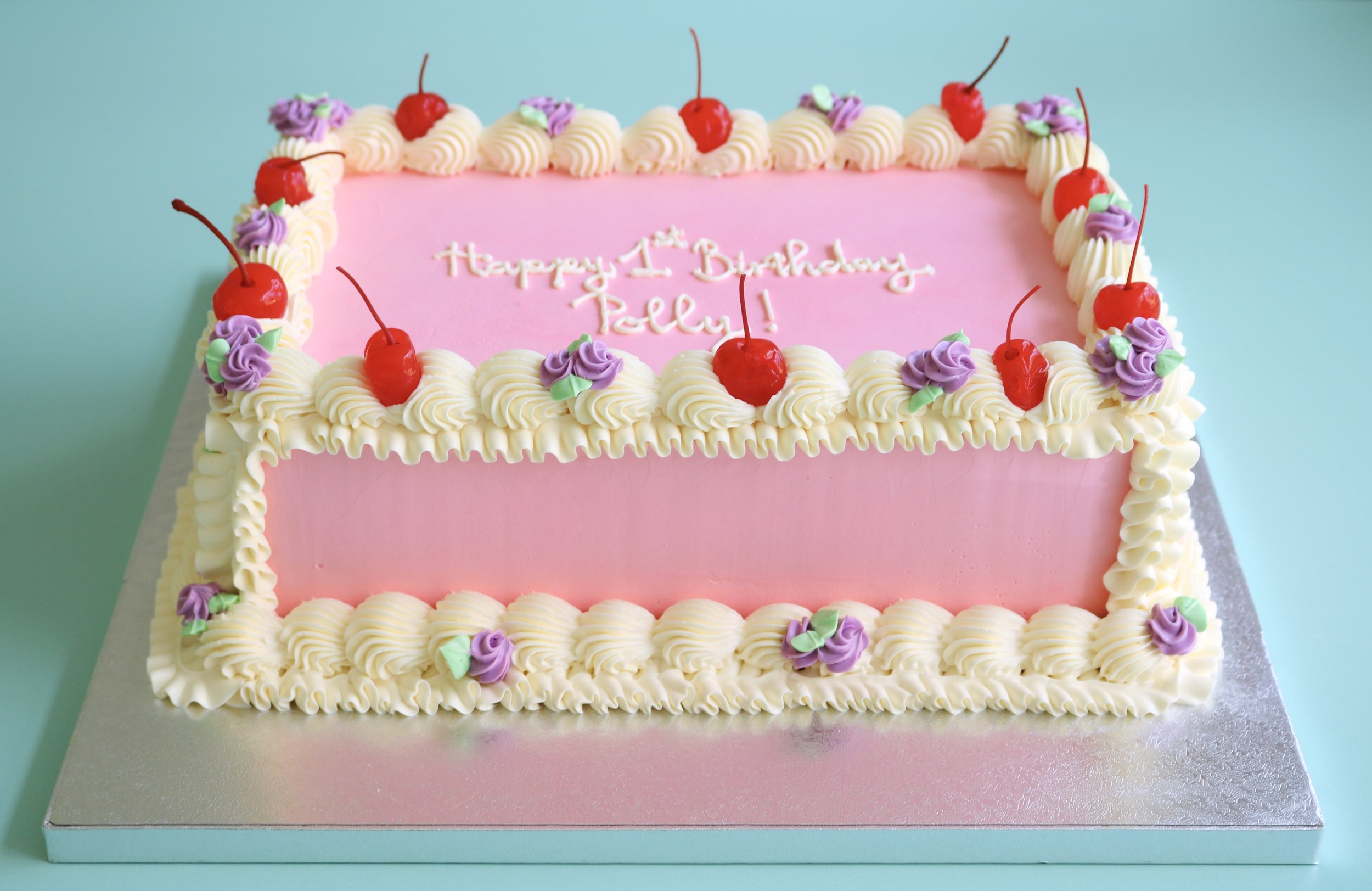 Luxury pink vintage rectangular birthday cake with Lambeth buttercream piping, cherries and pastel flowers in London.