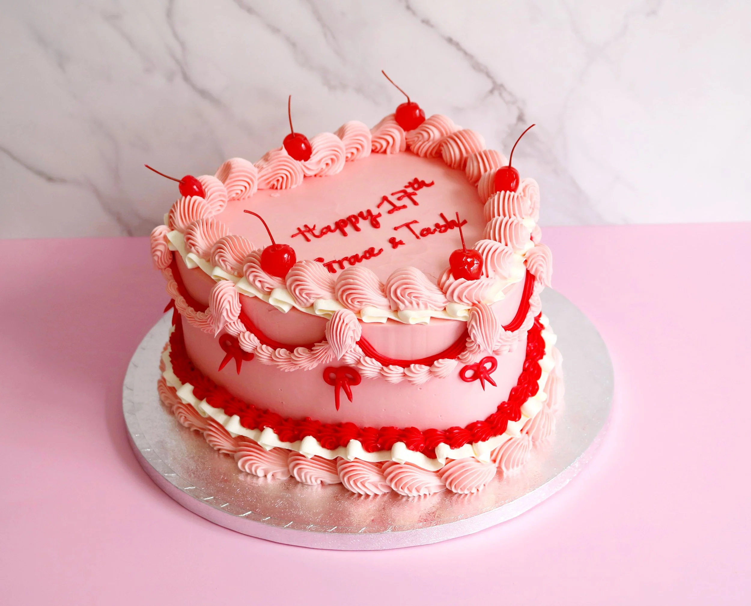 retro vintage heart cake decorated with bows and ruffles buttercream piping . The cake is perfect for any special occasions and there is option to have a customised message on the cake