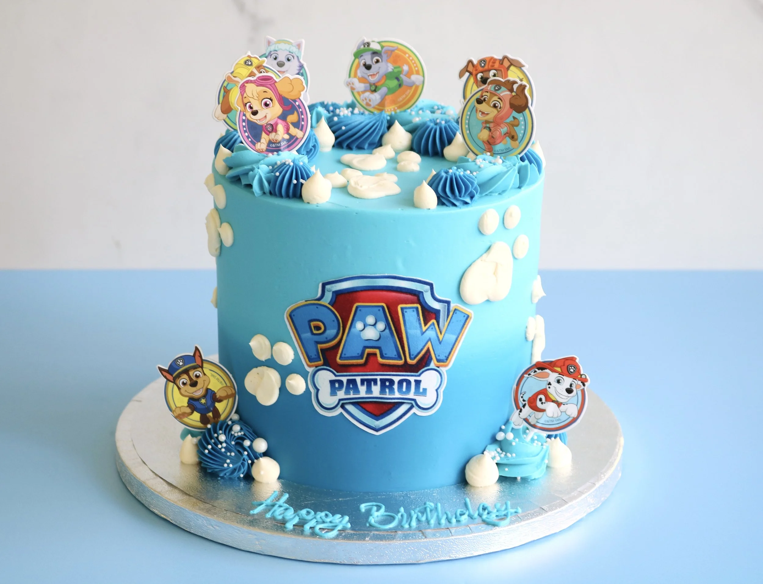 paw patrol cake for kid birthdays in london, decorated in blue and pink buttercream ombre cover