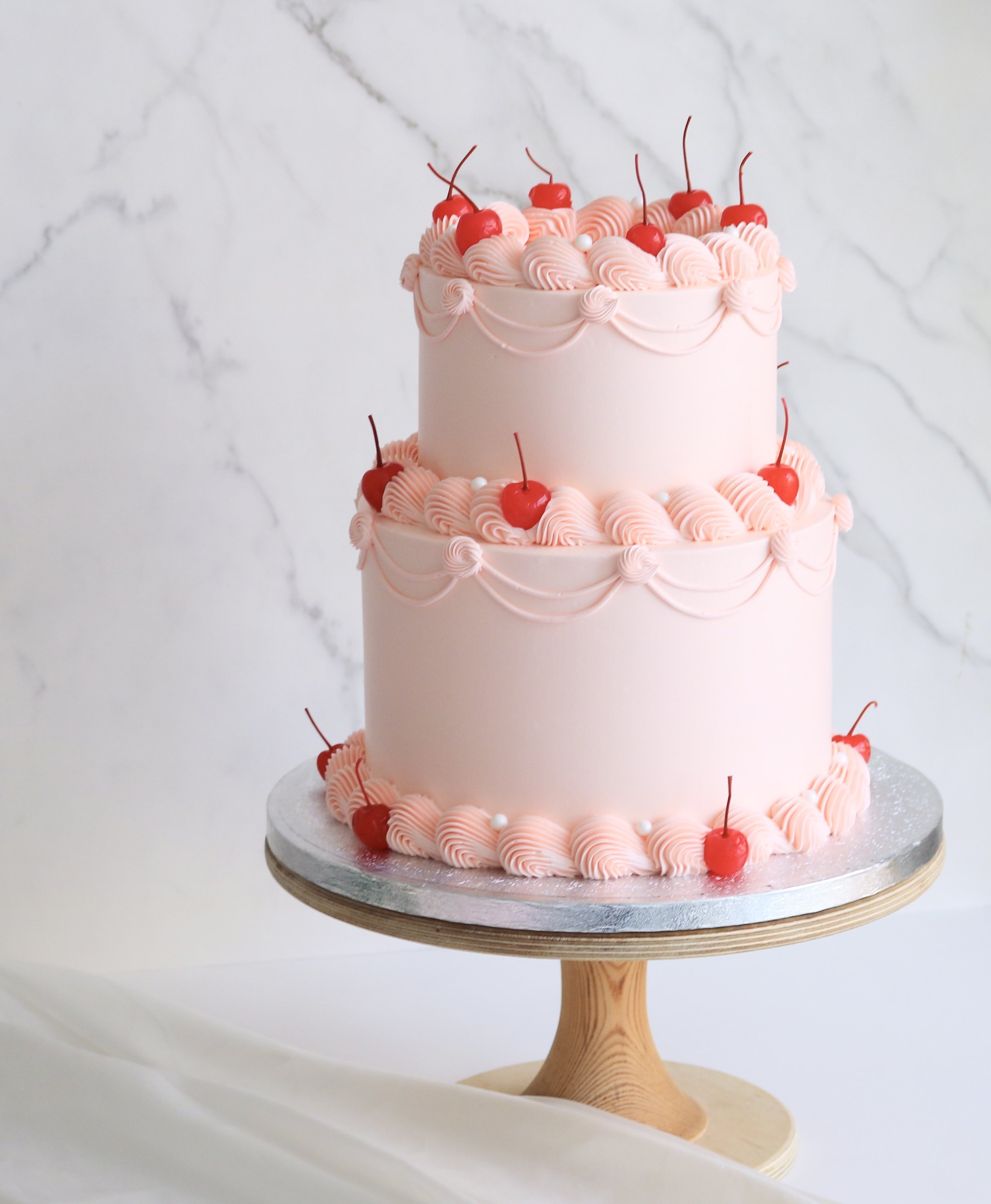 2 tiered vintage cake in blush pink theme with cherries and pearls in London