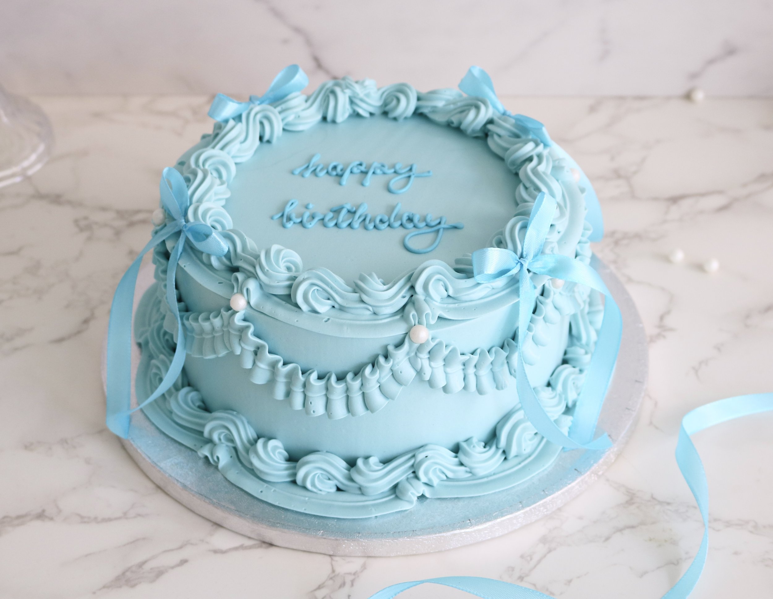 vintage cake with bow decorations in london