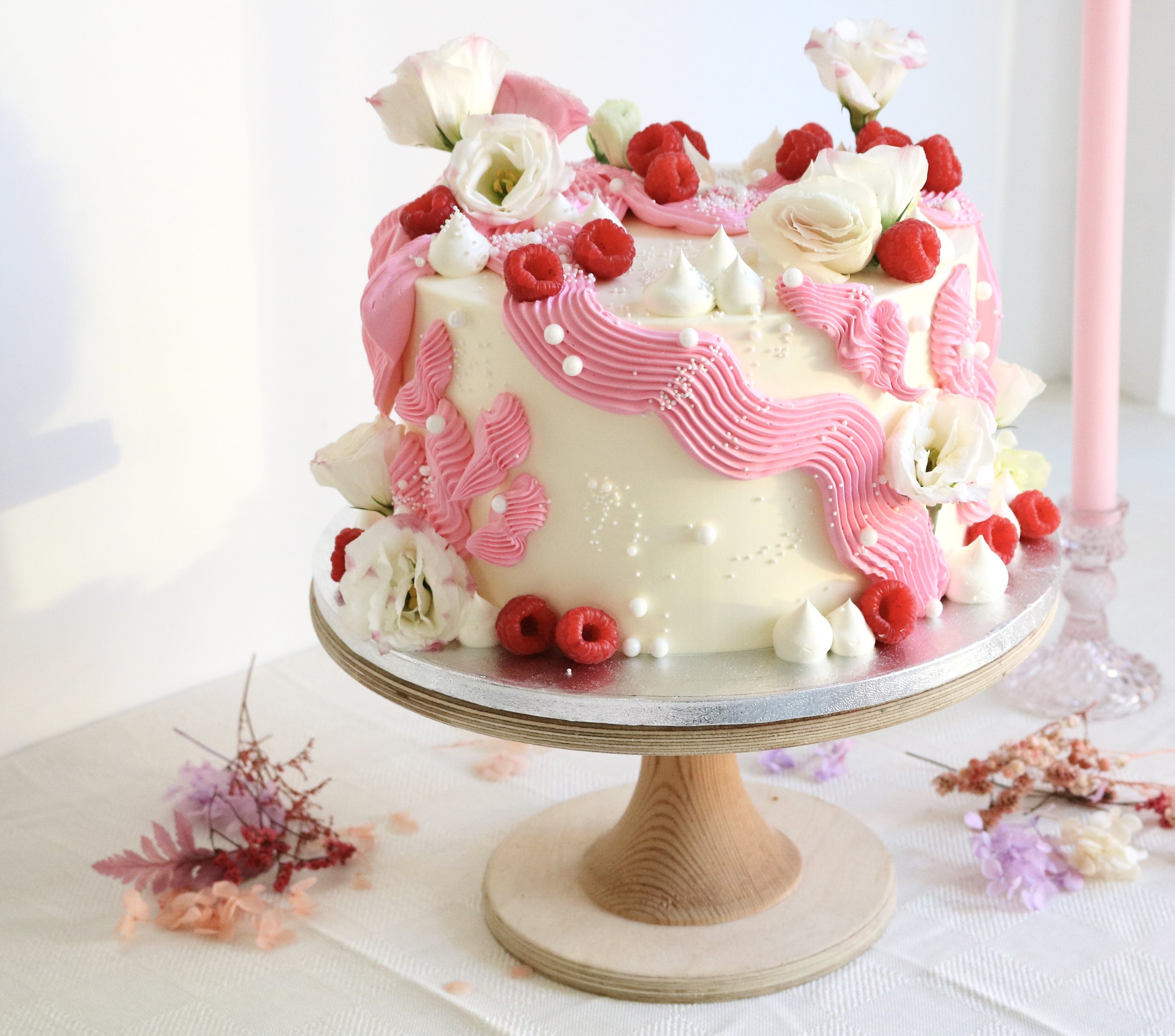 Birthday cake decorated with pink piping details, edible pearls and fresh berry fruits for al occasions in London