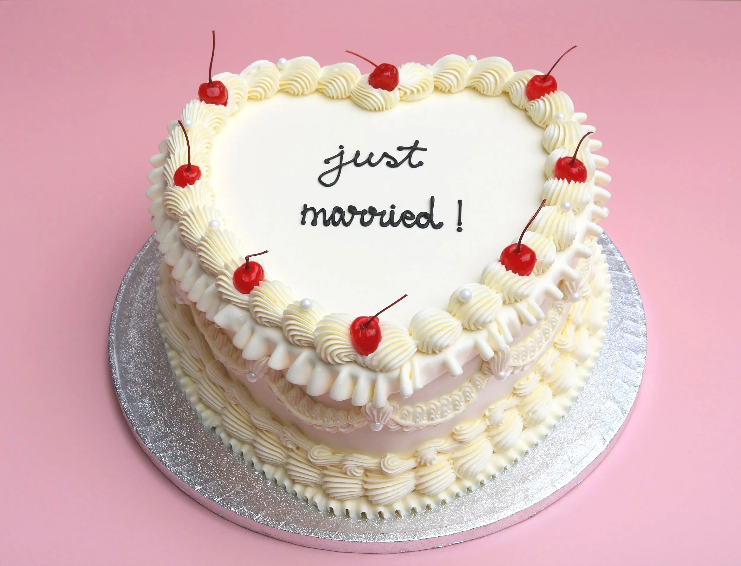 heart-shaped wedding cake with Just Married Message