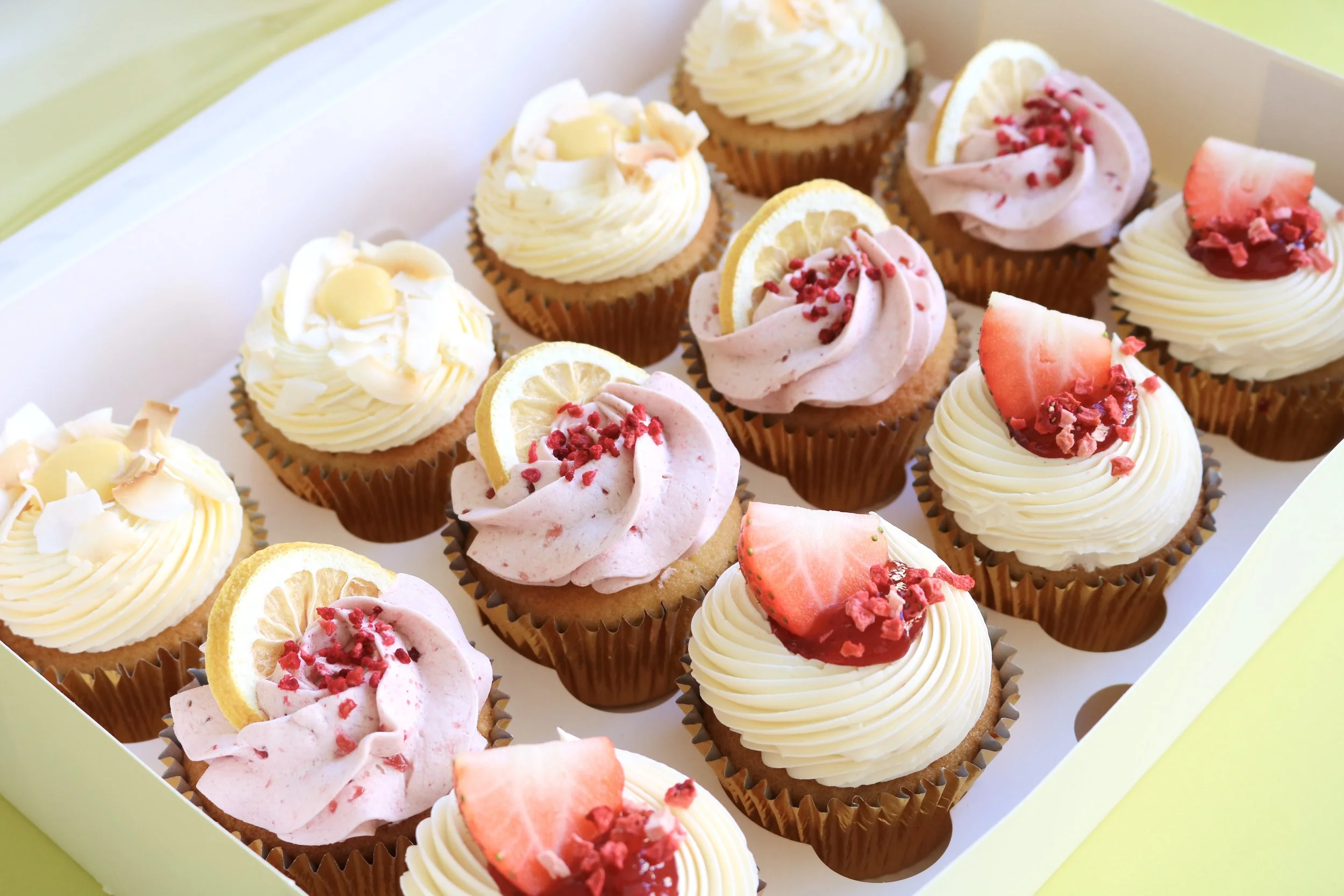 fruity cupcakes with strawberry buttercream, lemon raspberry frosting, fresh strawberries, and elegant decorations in London for company and corporate events