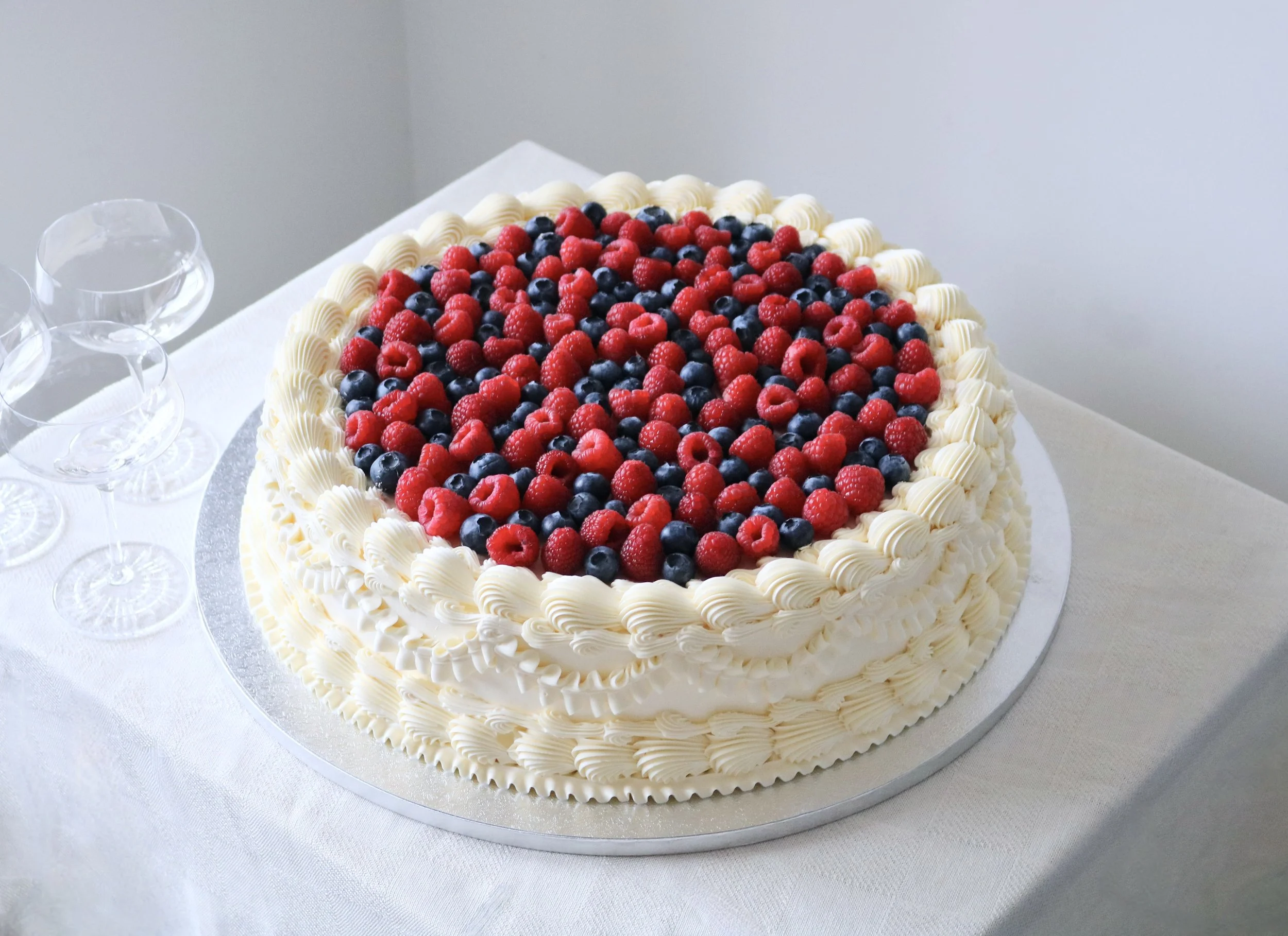 large vintage cake with fresh berries on top for weddings in London