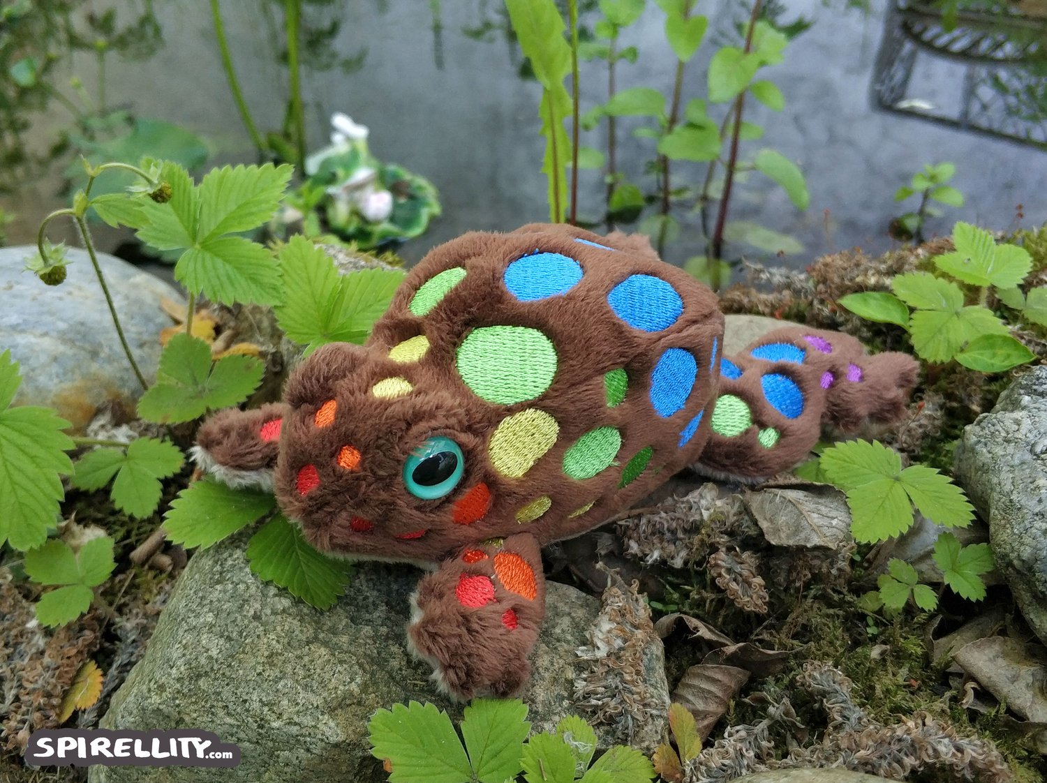 Plush toy of a toad with rainbow spots