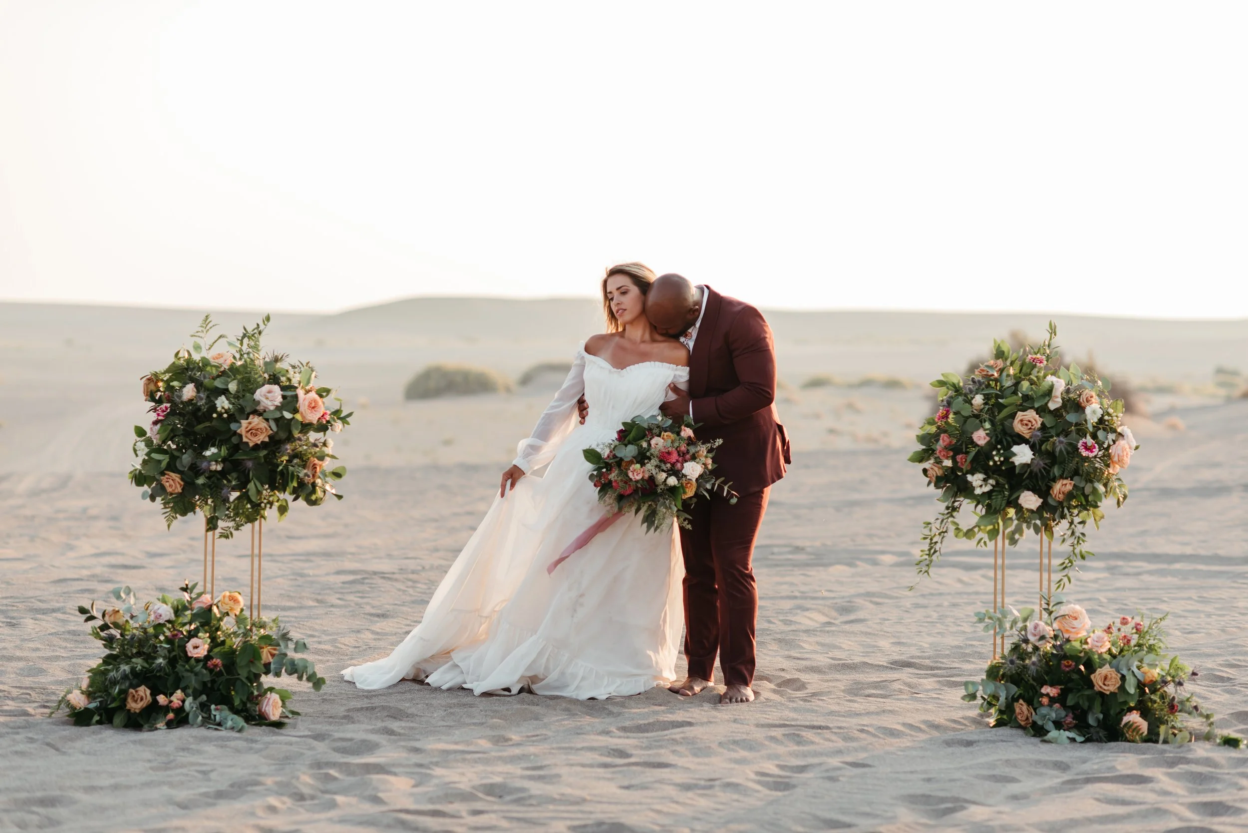 biracial couple during their elopement on the sand dunes in Christmas Valley, Oregon
