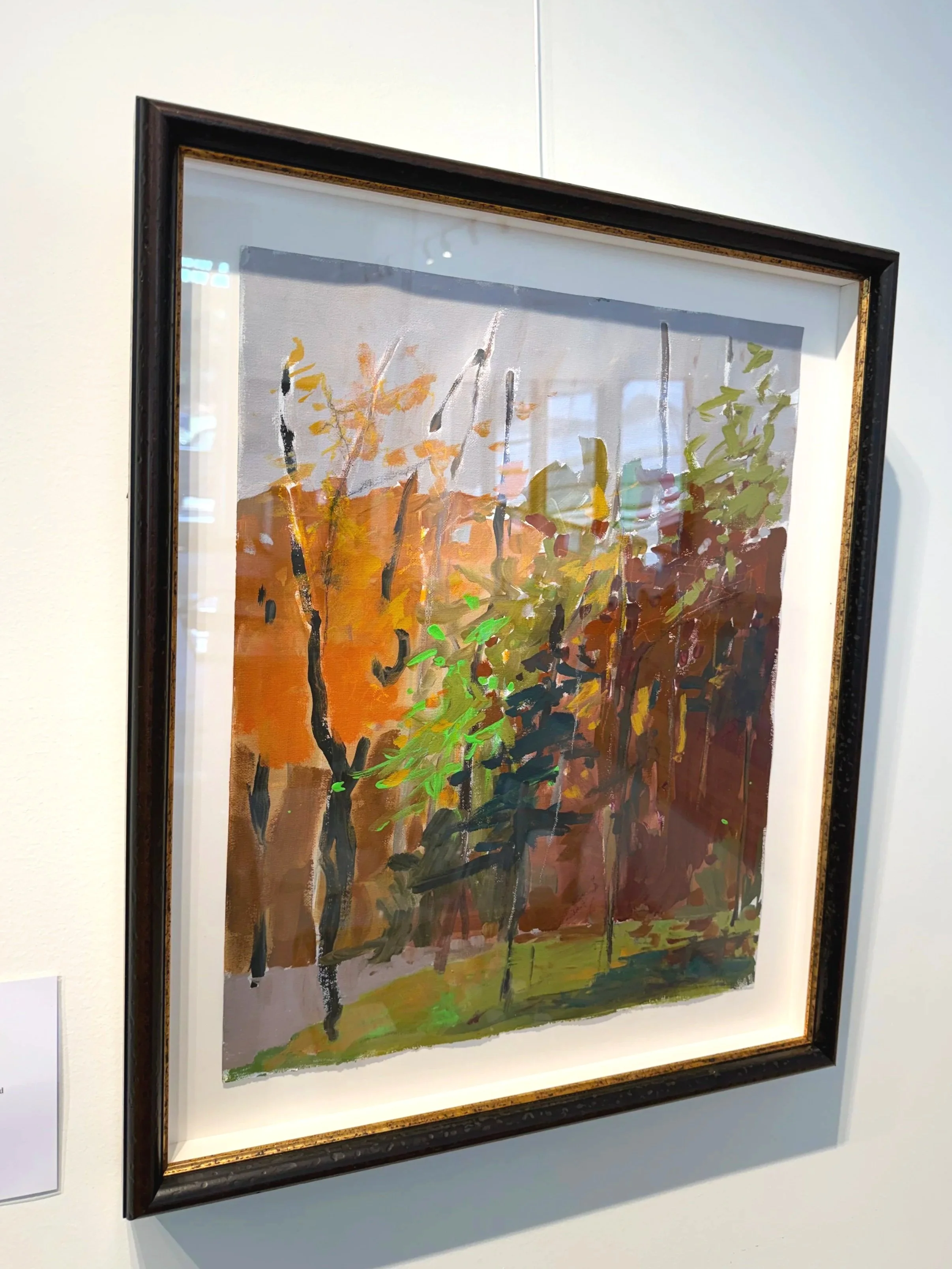 Framed acrylic fall landscape by Cheyenne Trunnell featuring warm autumn tones, displayed in a dark wood-and-gold frame, 16×20 inches.