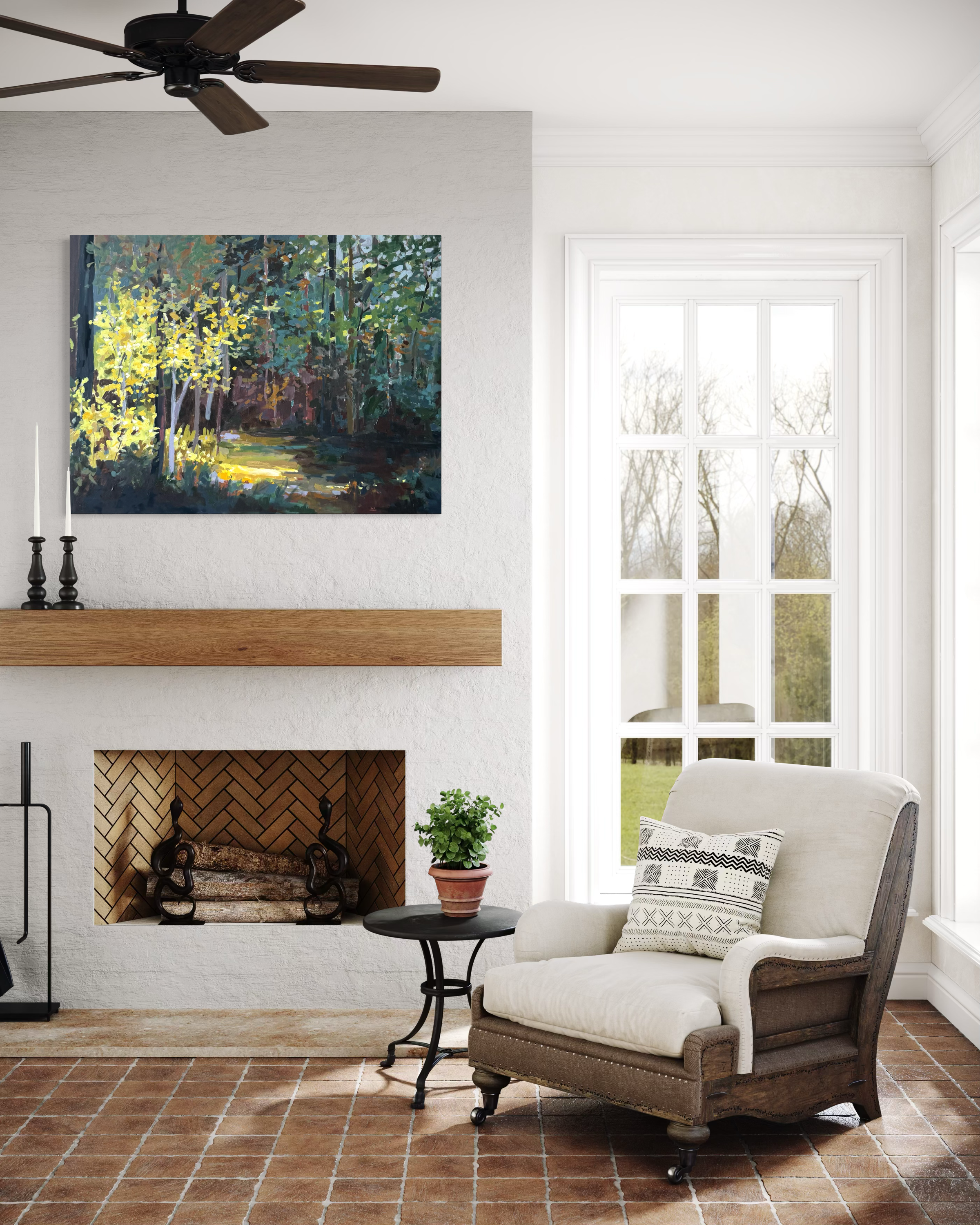 Original landscape painting with sunlit trees displayed above a fireplace in a bright living room. Nature-inspired artwork by Asheville artist Cheyenne Trunnell.