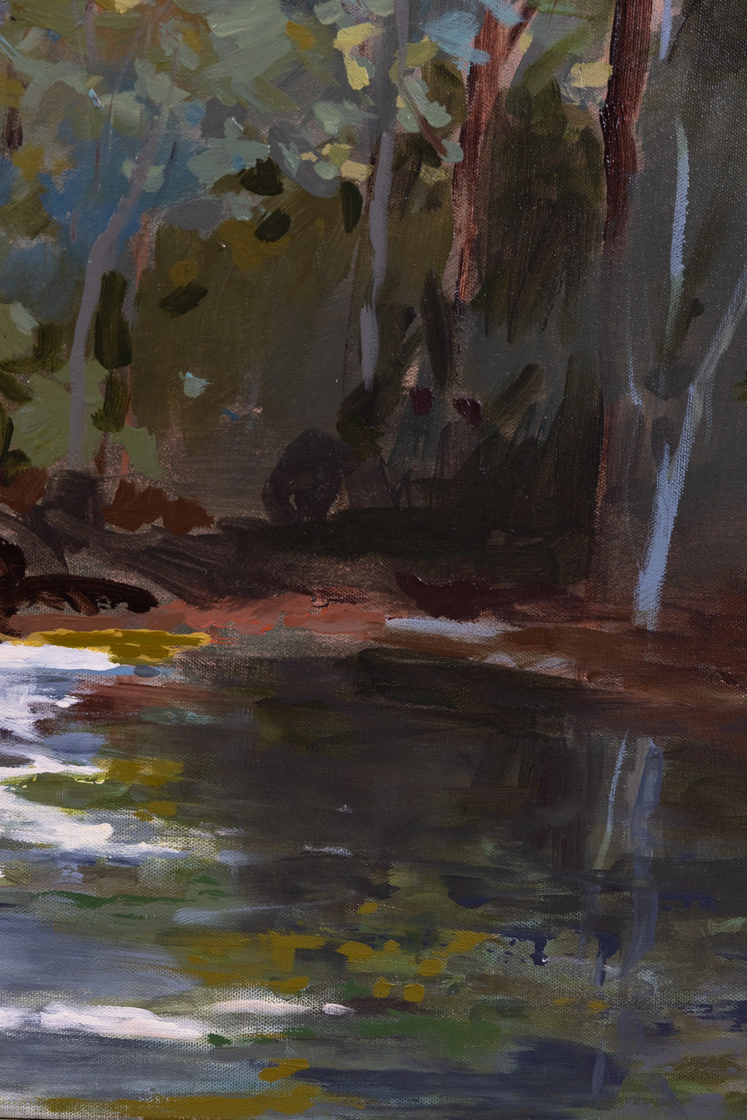 Detail of At the Edge of Stillness showing dark reflective water, wooded shadows, and soft highlights along the shoreline.