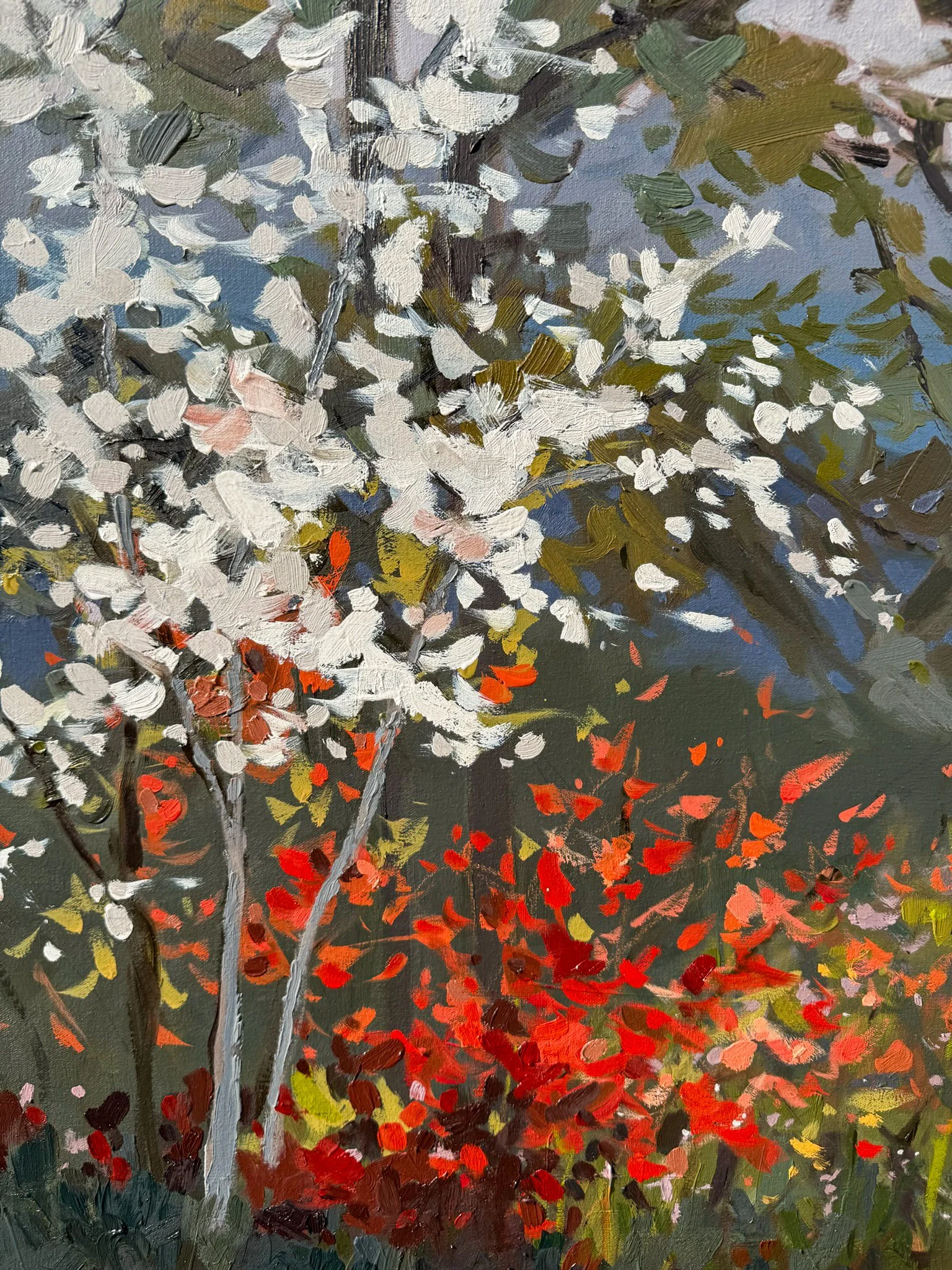 Close-up detail of an oil painting showing white spring blossoms above vivid red wildflowers, with expressive brushwork and layered color capturing the light of early morning.