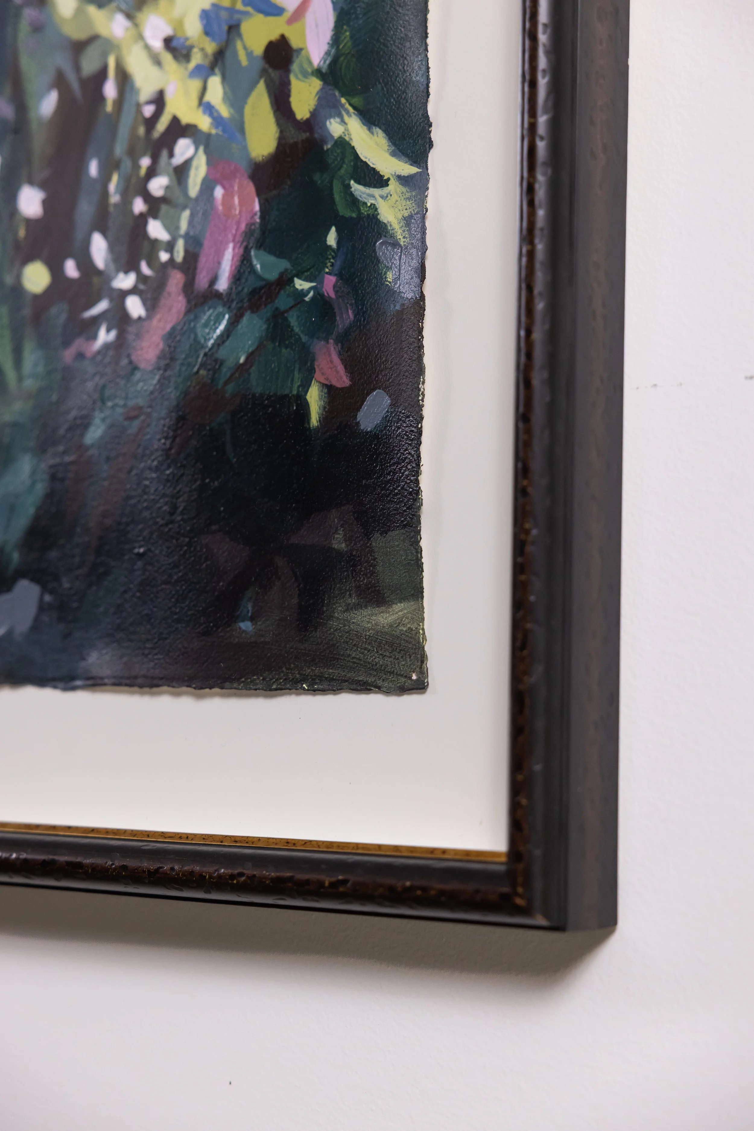 Detail of framed abstract floral painting by Asheville artist Cheyenne Trunnell showing brushwork and dark wood frame.