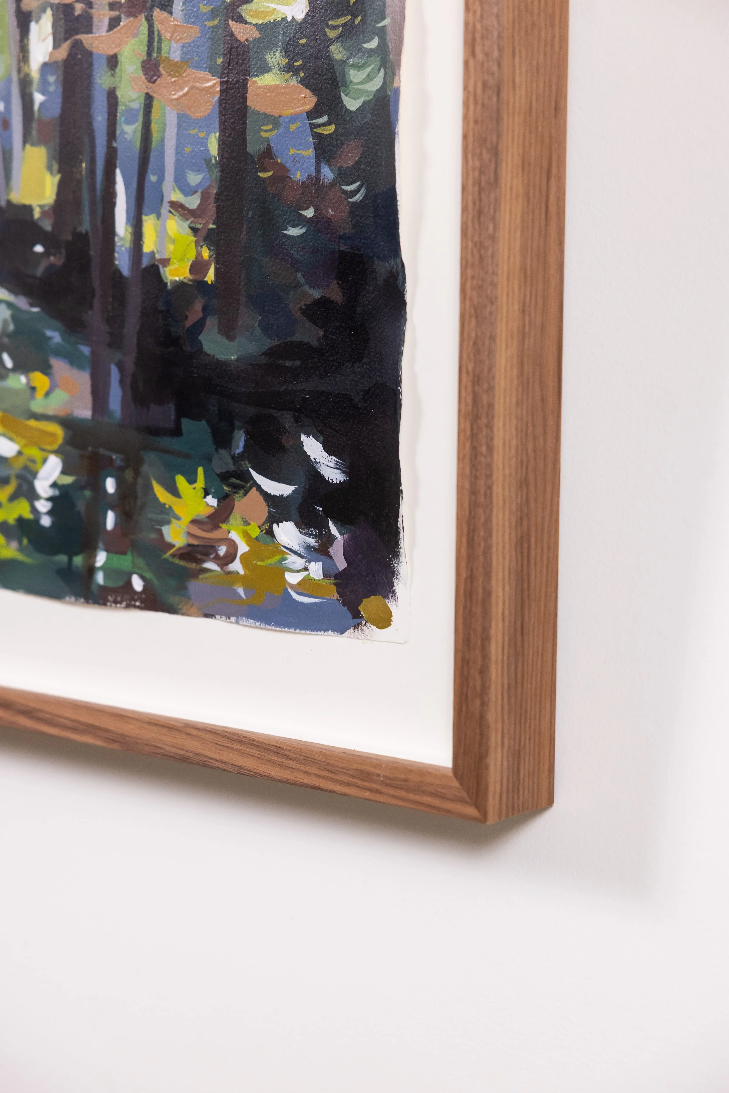 Detail of framed landscape painting by Asheville artist Cheyenne Trunnell showing brushwork and wood frame.