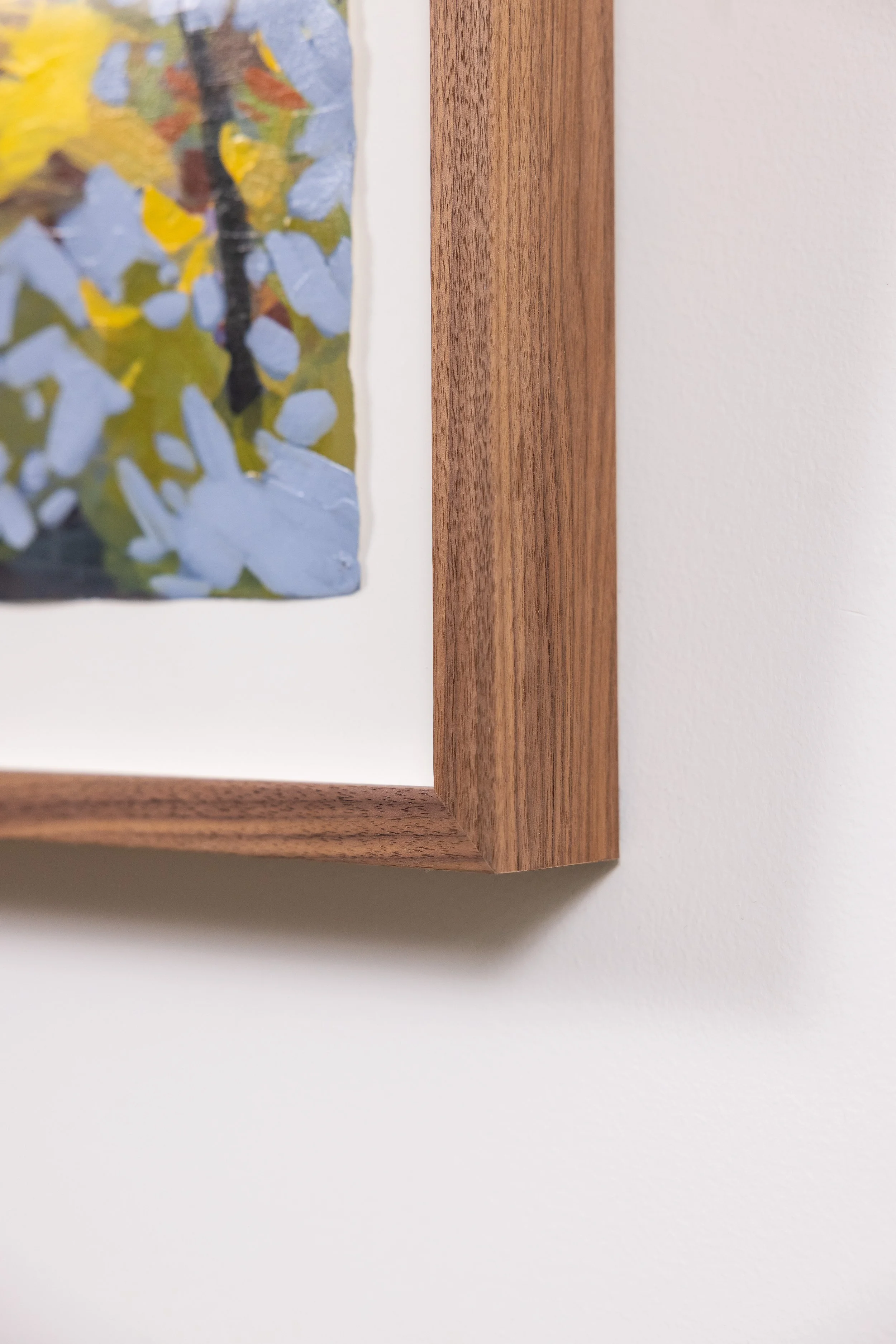 Detail of framed landscape painting by Asheville artist Cheyenne Trunnell showing brushwork and wood frame.