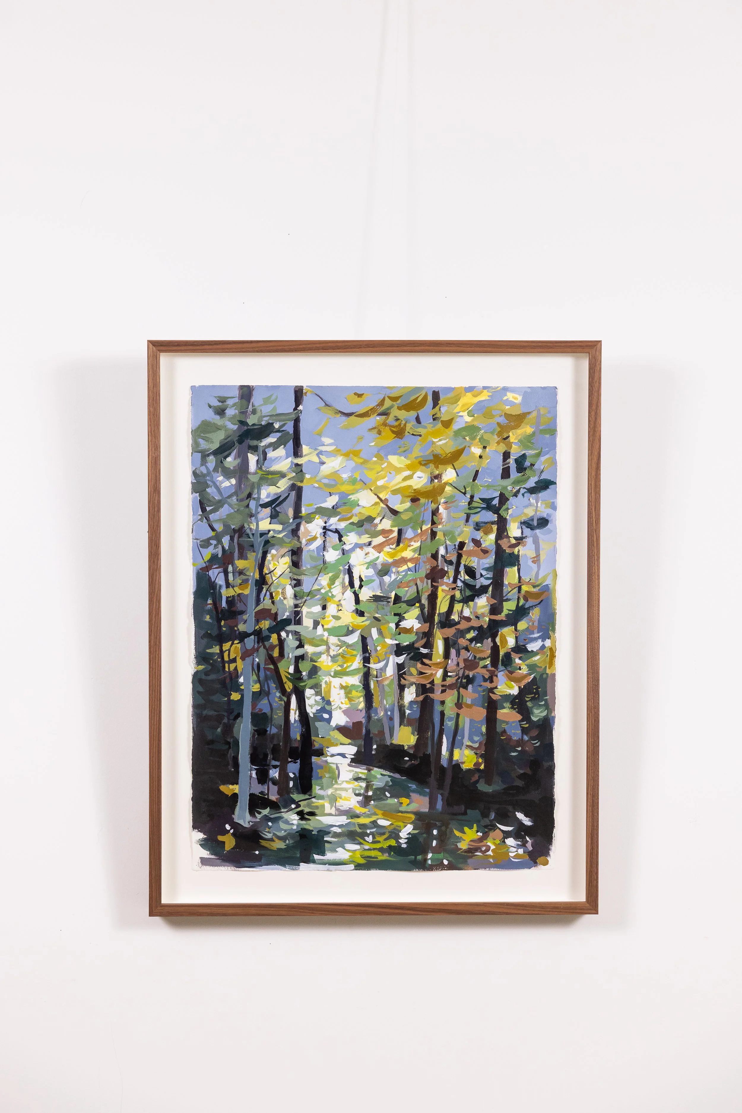 Framed landscape painting by Asheville artist Cheyenne Trunnell depicting light filtering through trees.