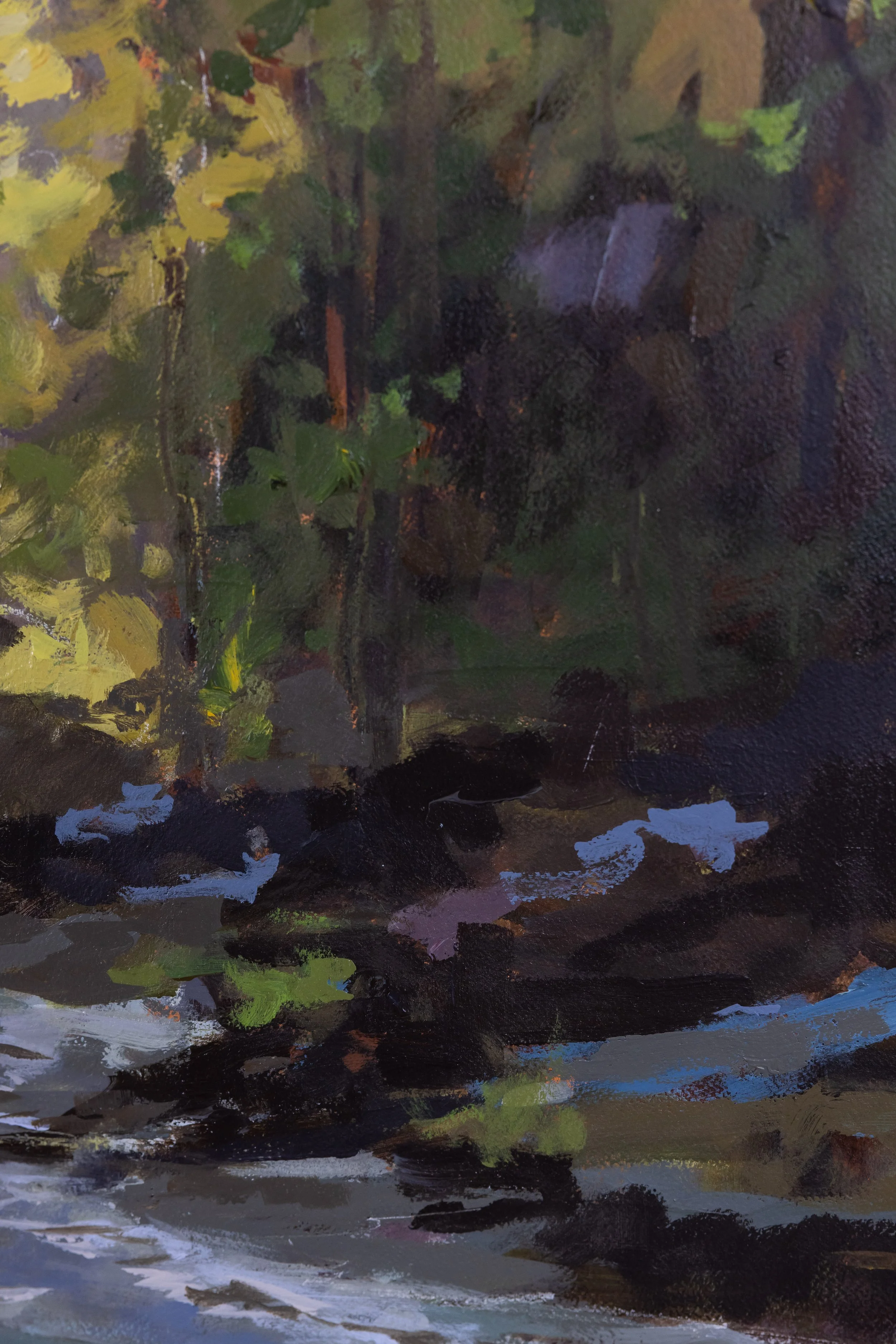 Detail of A Glimmer of Light by Cheyenne Trunnell, showing dark forest shadows, blue-gray water, and bright green and yellow brushwork along the stream.