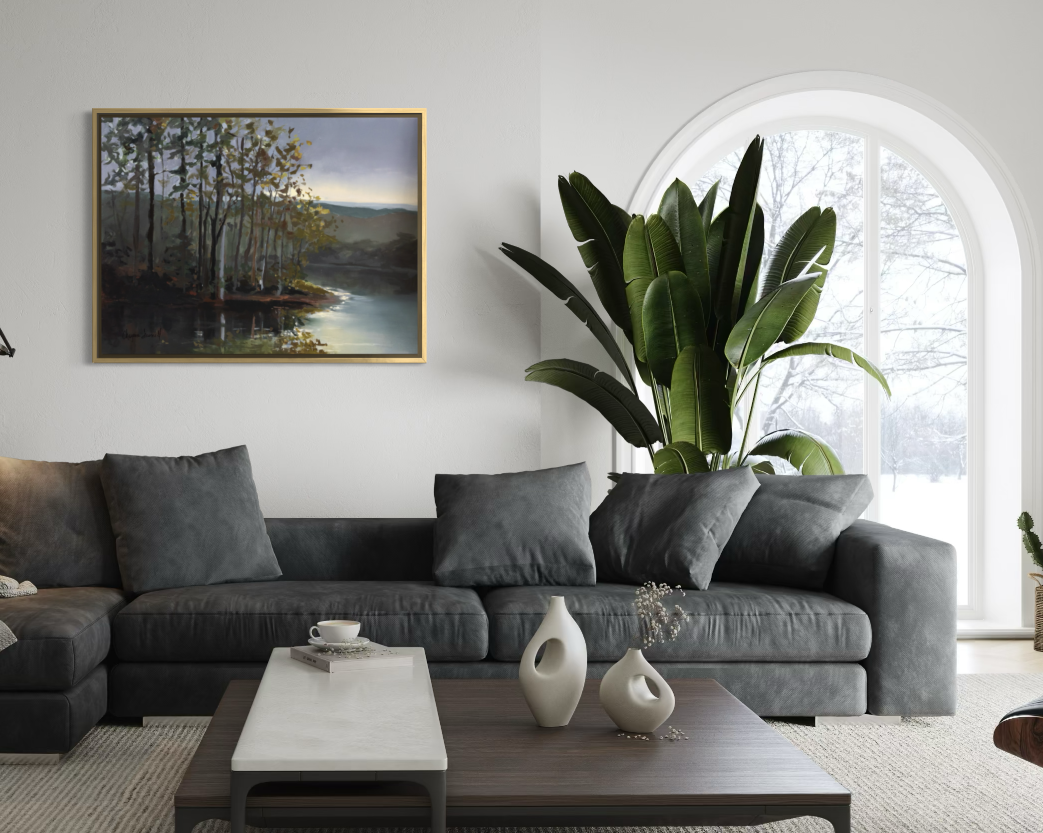 The First Glimpse of Light by Cheyenne Trunnell, shown framed above a charcoal sofa in a bright contemporary living room with an arched window and large green plant.