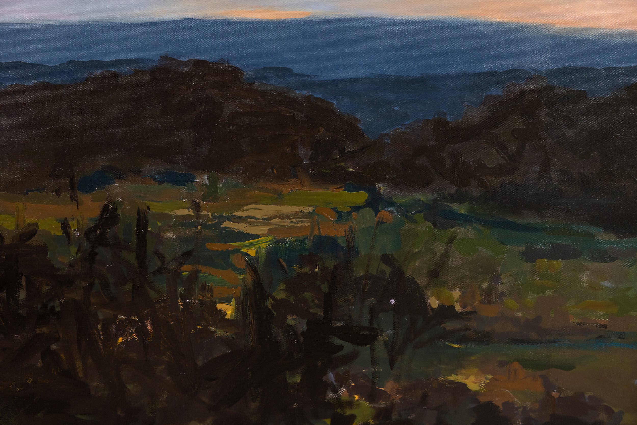 Detail of original oil landscape painting by Asheville artist Cheyenne Trunnell emphasizing atmospheric depth through layered hills, shadowed forms, and soft evening light, framed.