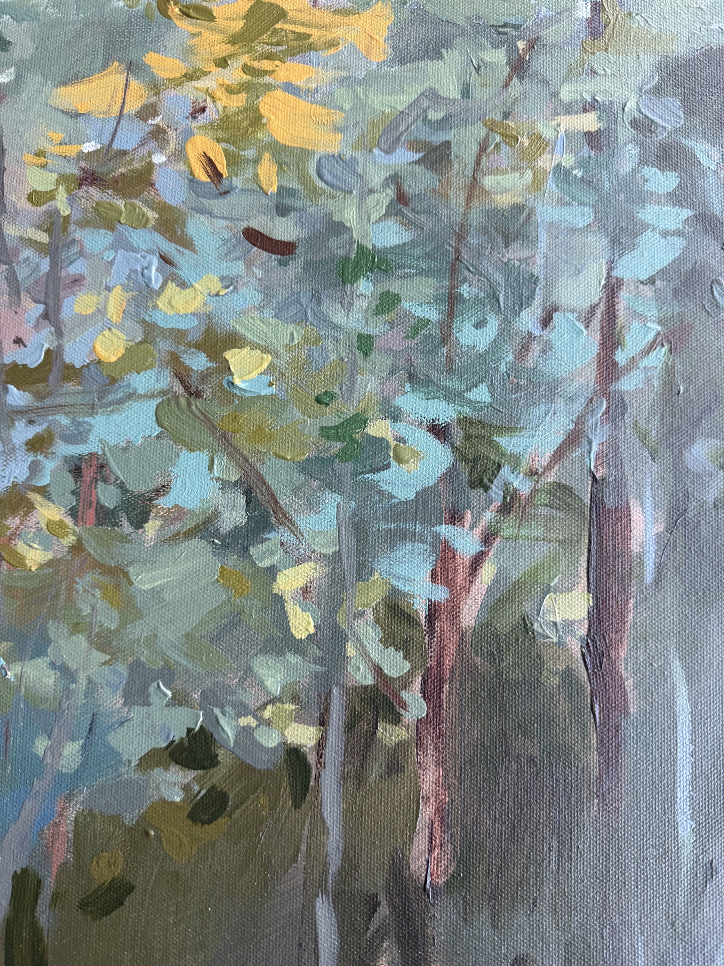 Detail of layered blue-green foliage, slender tree trunks, and golden leaves in Cheyenne Trunnell’s forest landscape painting.