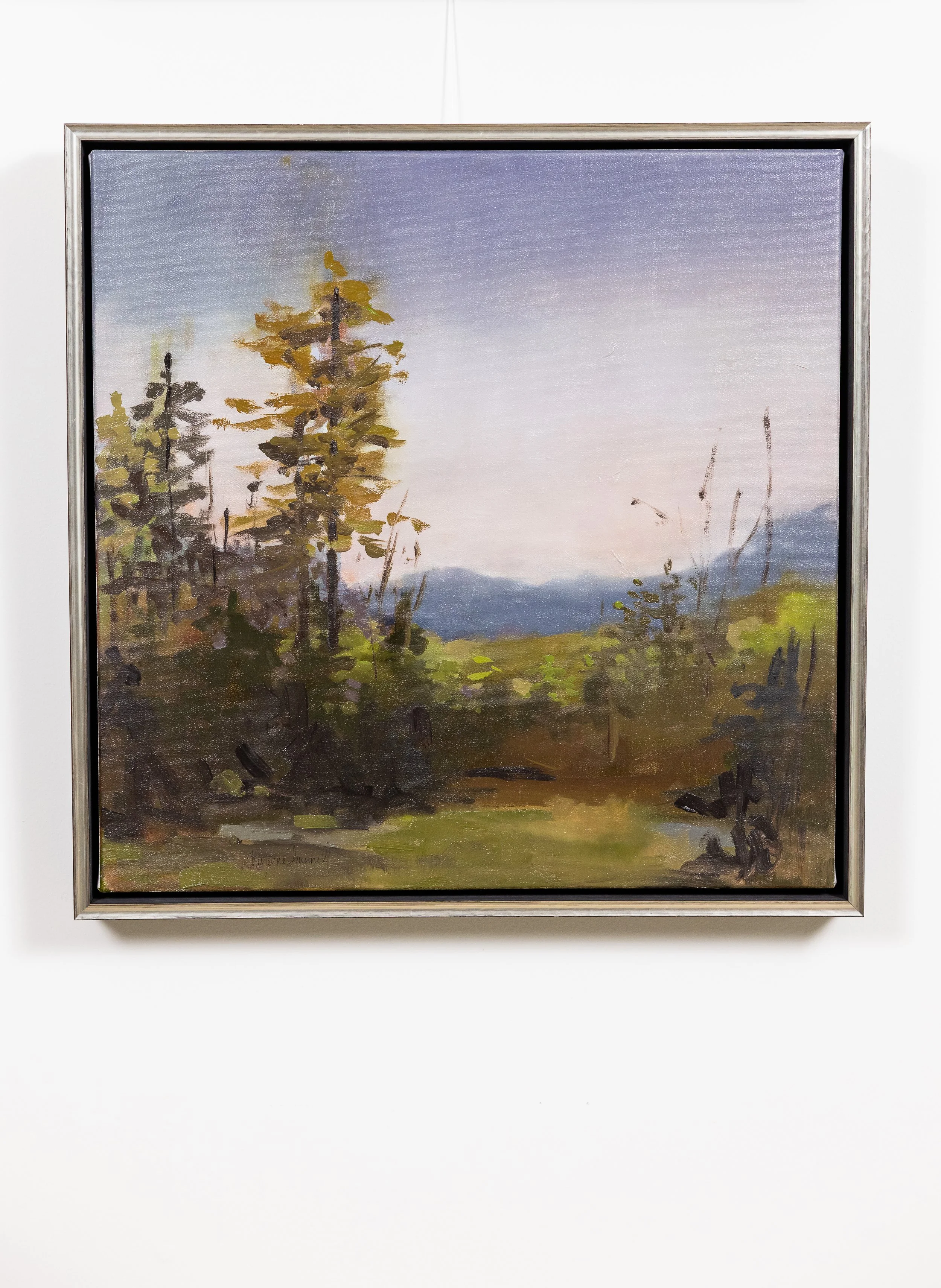 Framed oil landscape painting by Asheville artist Cheyenne Trunnell depicting morning light illuminating a quiet Western North Carolina valley with trees and distant blue mountains.