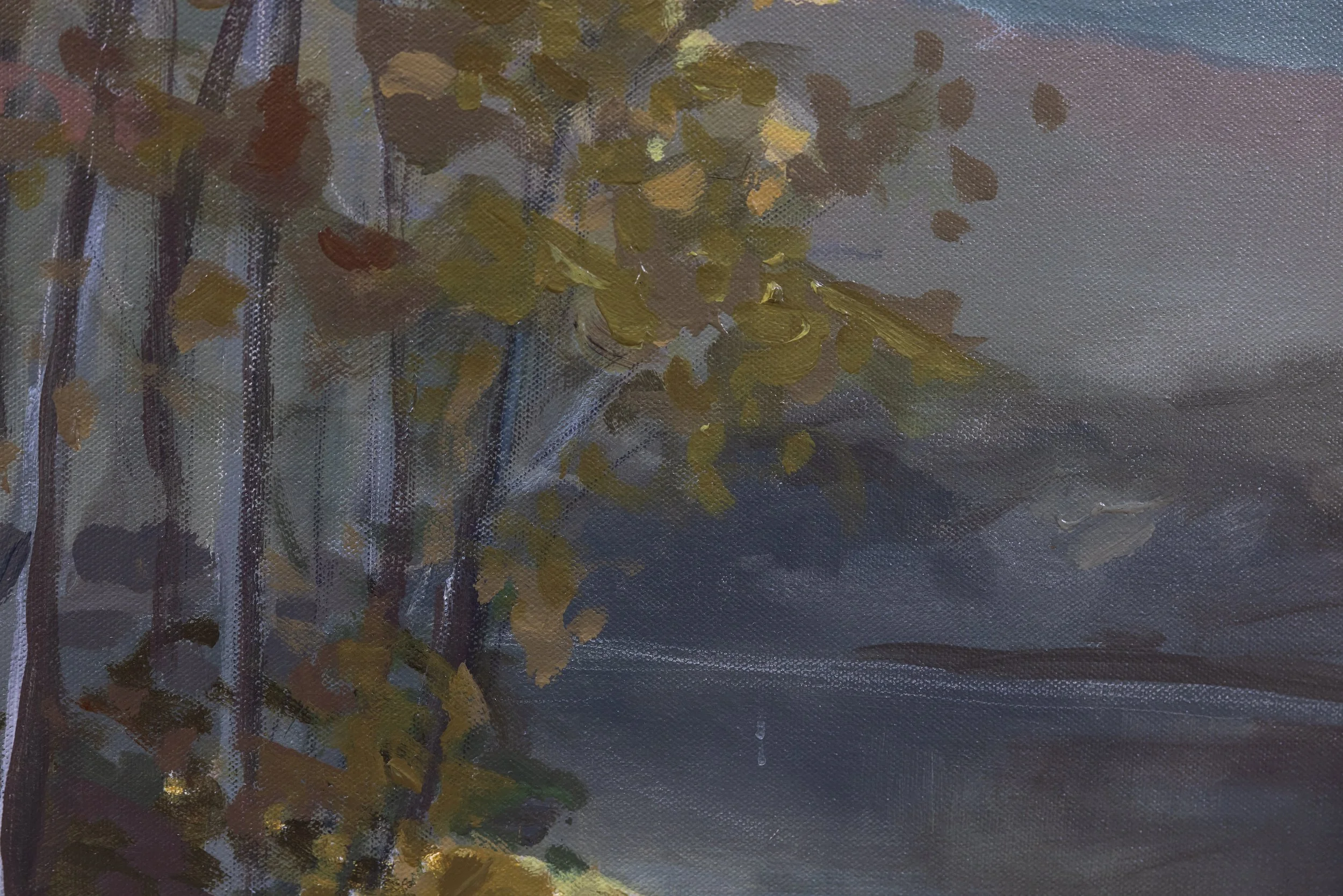 Close-up of The First Glimpse of Light highlighting golden autumn leaves, soft blue-gray mountains, and a luminous morning sky.