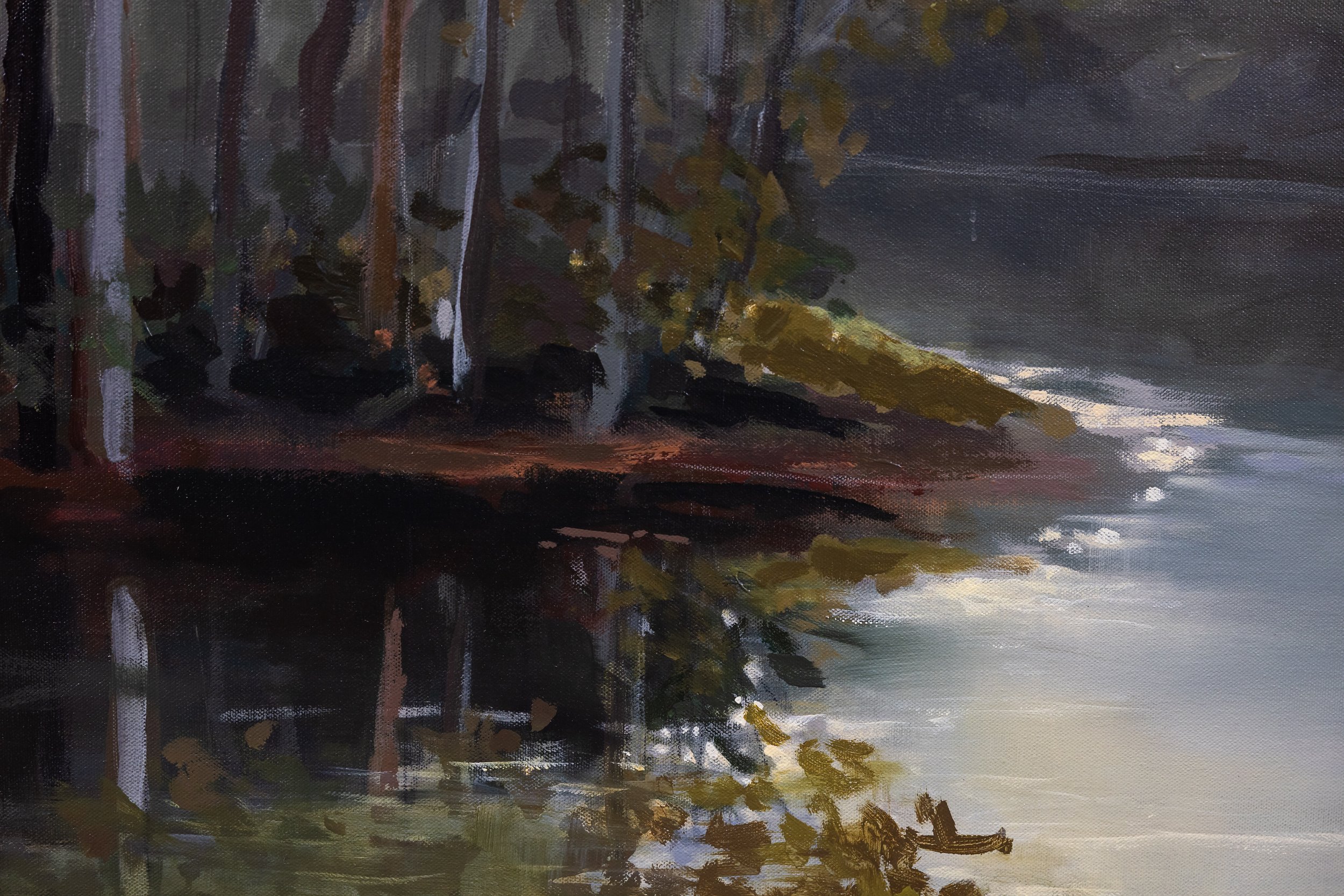 Detail of The First Glimpse of Light by Cheyenne Trunnell, showing reflected trees and pale light shimmering across the water near the wooded shoreline.