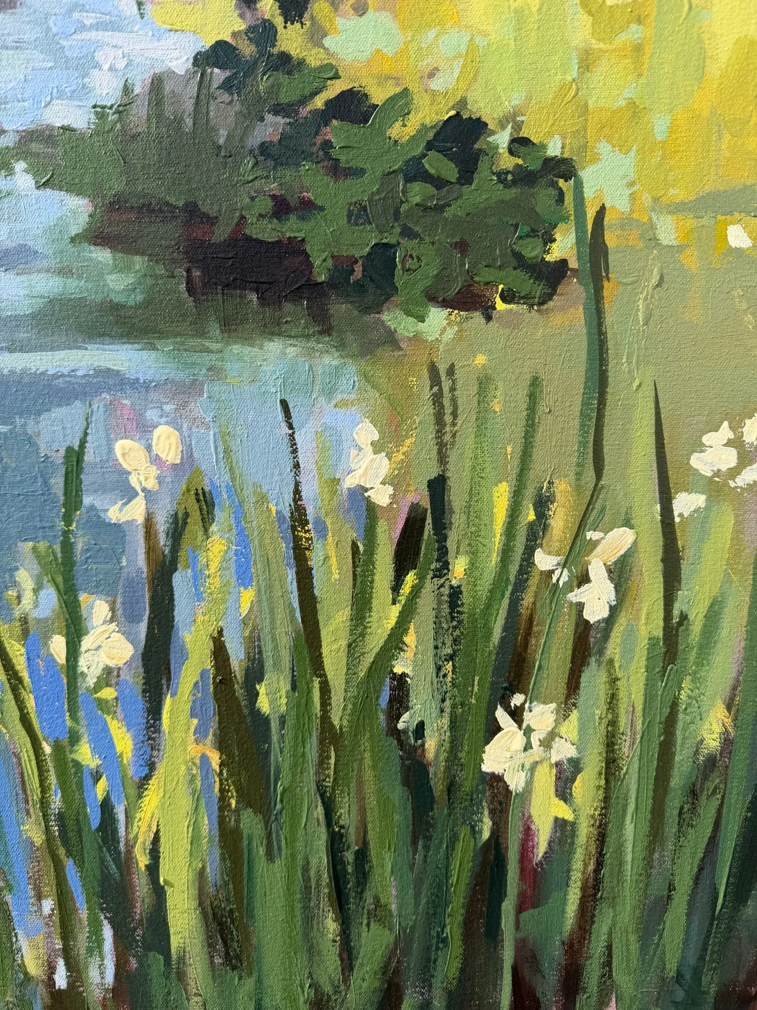Close-up of Beside the Still & Quiet Water highlighting tall grasses, pale yellow blooms, and soft blue water reflections.