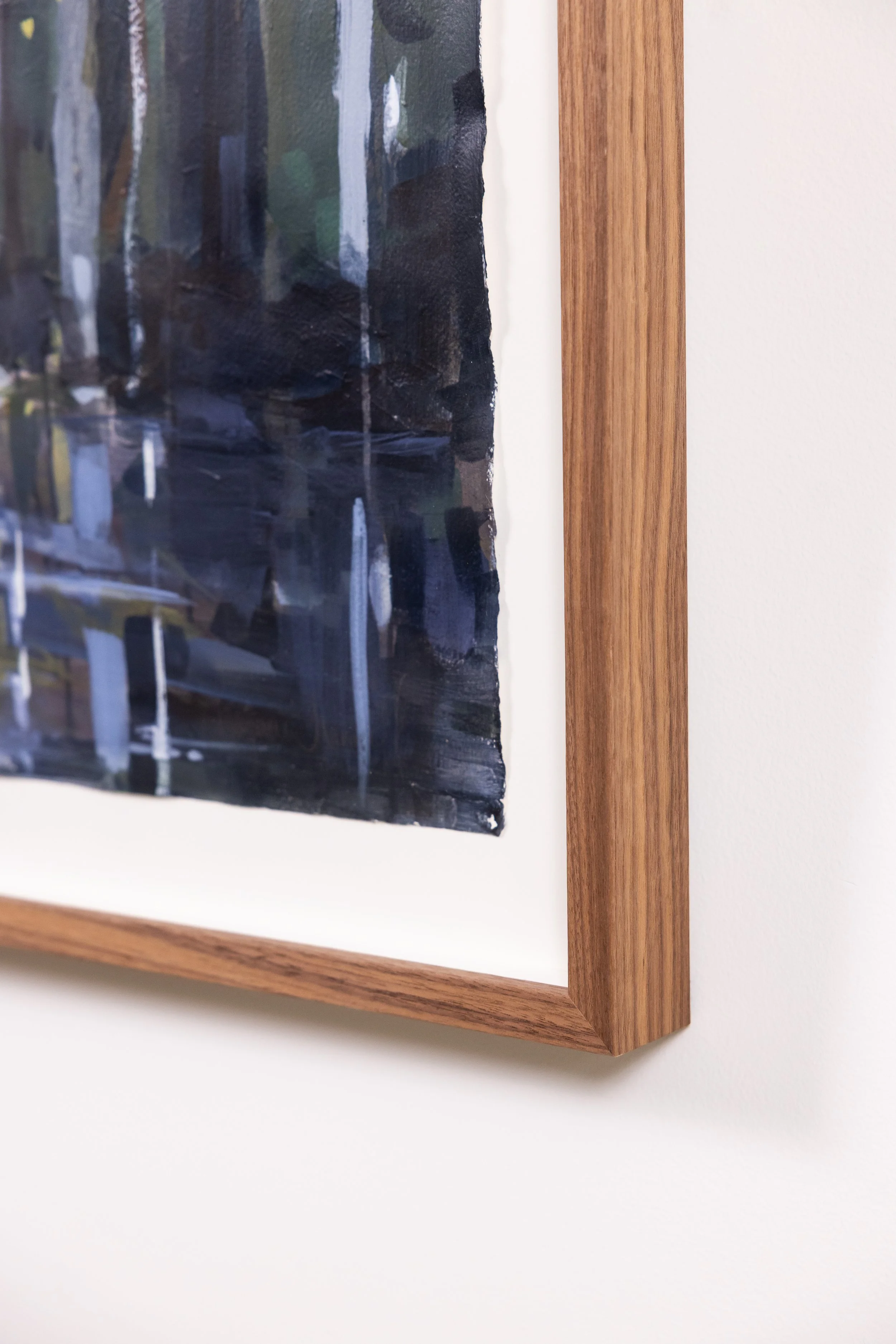 Detail of framed landscape painting by Asheville artist Cheyenne Trunnell with visible brushwork and wood frame.