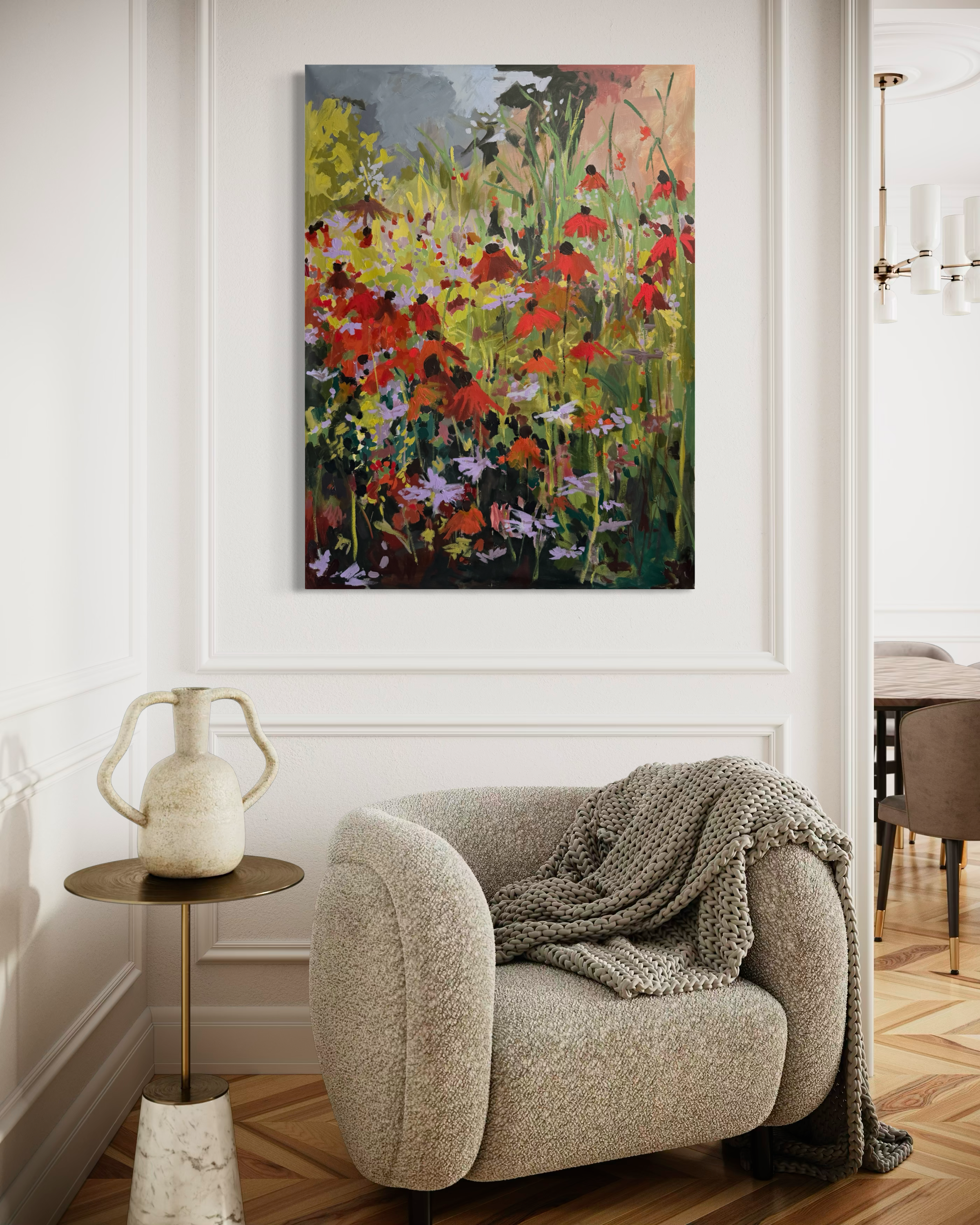 Large original floral painting with red coneflowers and wildflowers displayed above a reading chair in a bright, elegant interior. Original artwork by Asheville artist Cheyenne Trunnell.