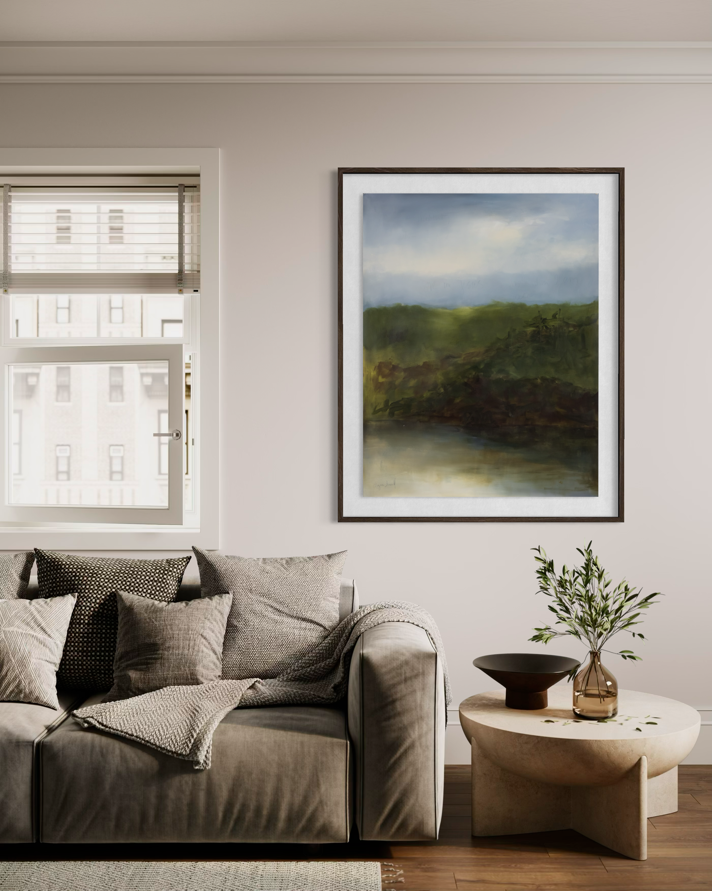 On the Wings of Dawn I by Cheyenne Trunnell, shown framed above a neutral sofa in a warm contemporary living room.