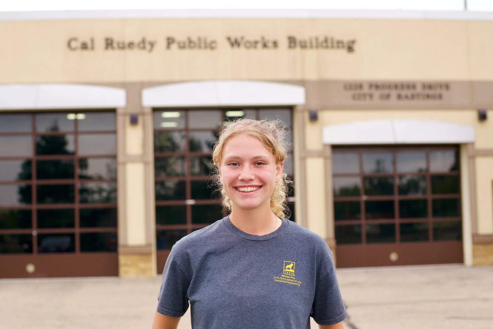 Elsie Jacobs outside the Cal Ruedy Public Works Building in Hastings after completing her 2026 engineering internship.