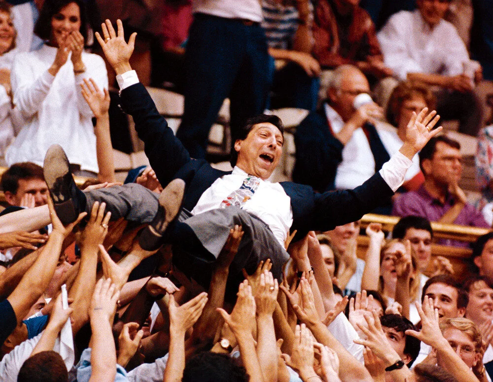 Valvano crowdsurfs while announcing a game in the early 1990s.