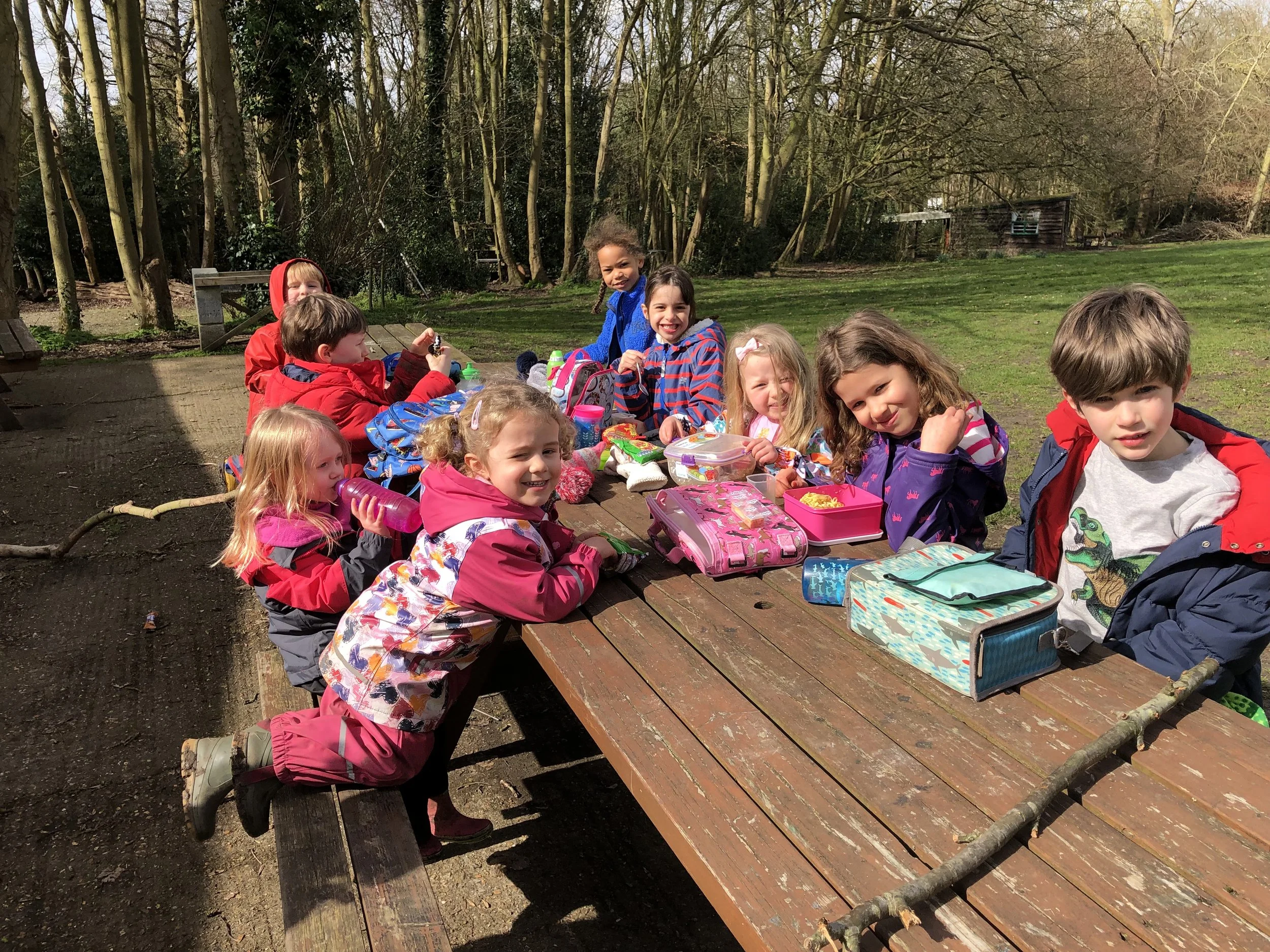 Children having lunch at a bench