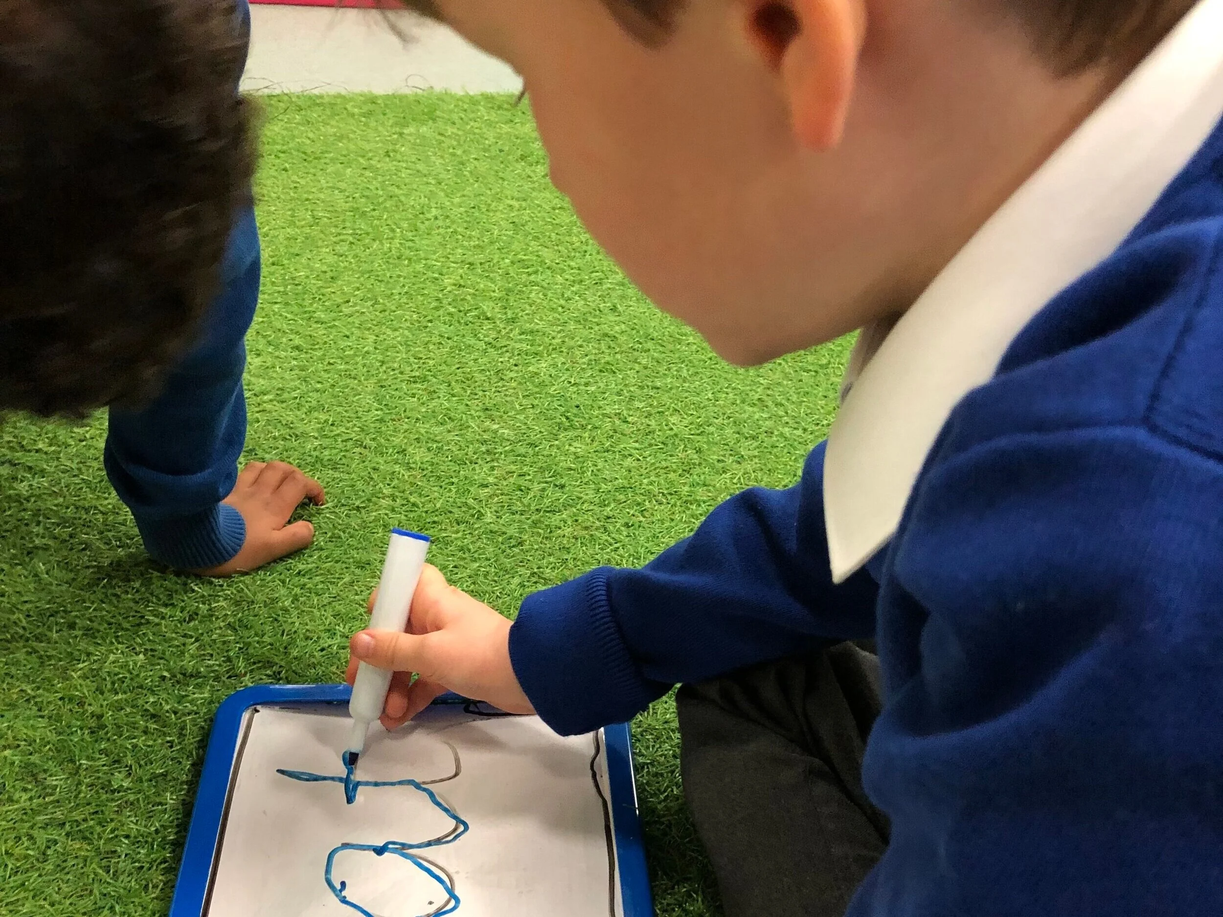 Child writing on whiteboard