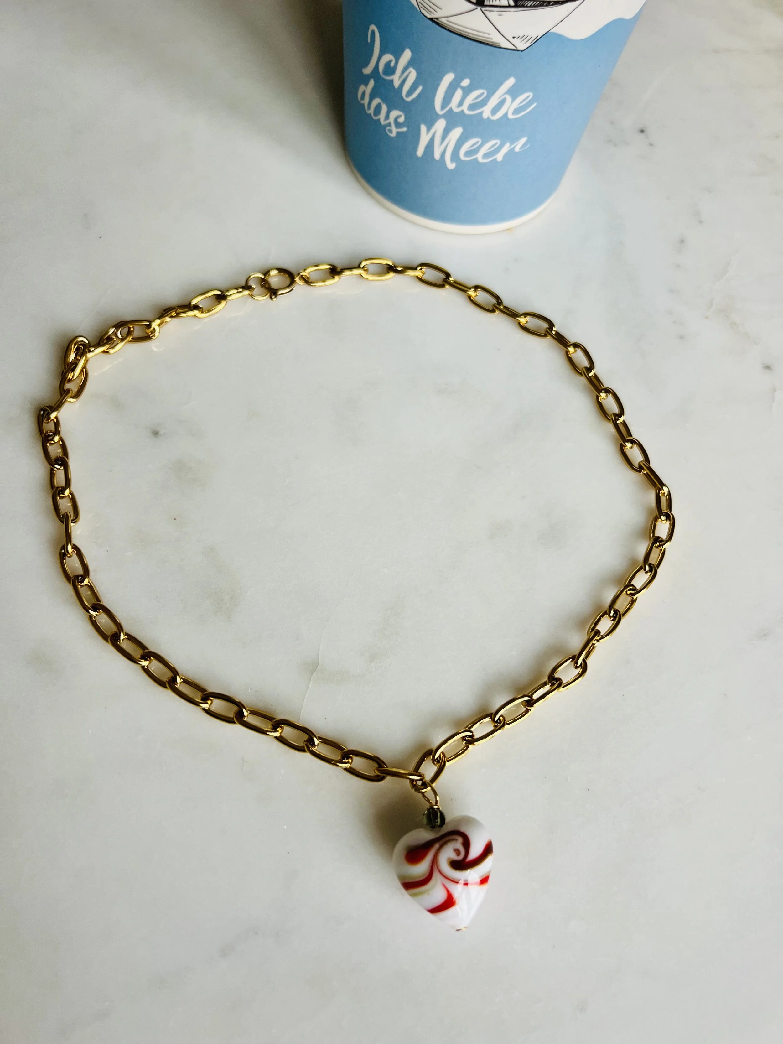 Produktfoto der Gladys Big White Heart – handgefertigte Vintage-Kette mit großem weißem Murano-Glasherz an einer wasserfesten Edelstahlkette mit Goldfinish.
