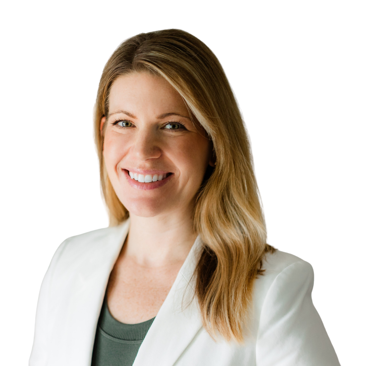 A woman with shoulder-length light brown hair, smiling, wearing a white blazer over a dark green top, standing against a plain light-colored background.