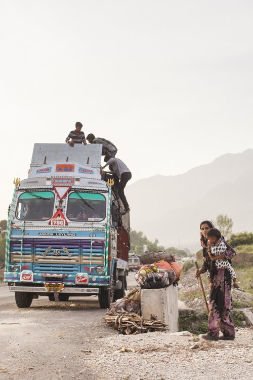 ‘A Gujjar family loads their belongings in the truck, which include cloth bags bound by coir and bundles of wood to keep them warm in the alpine pastures’. Photo: Ozzie Hoppe