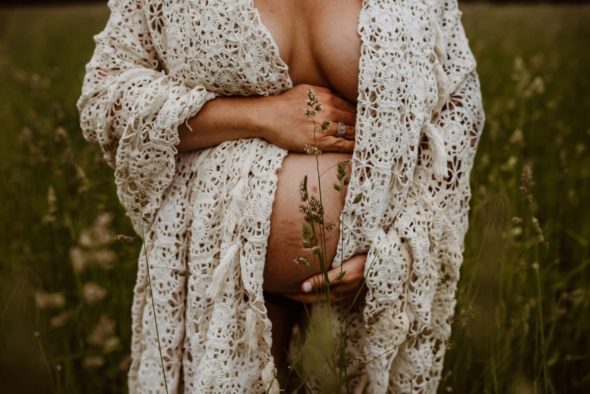 Pregnant person in field with flowers in Maine