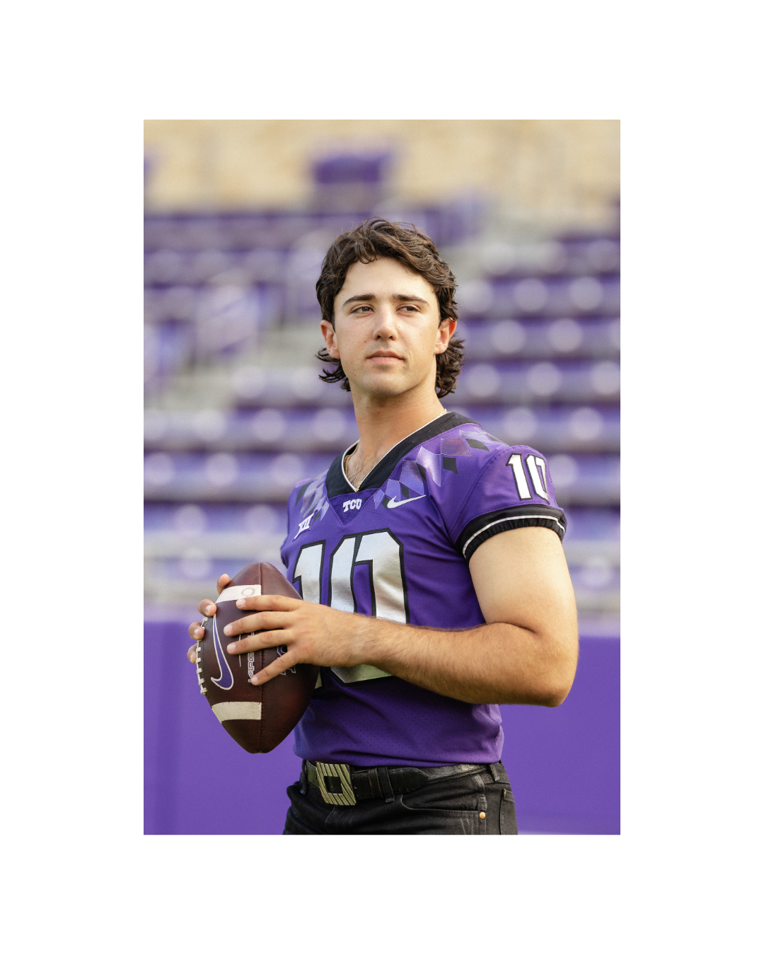 A college football player in a purple TCU jersey with the number 10, holding a football, standing on the Amon G Carter field with purple bleachers in the background.