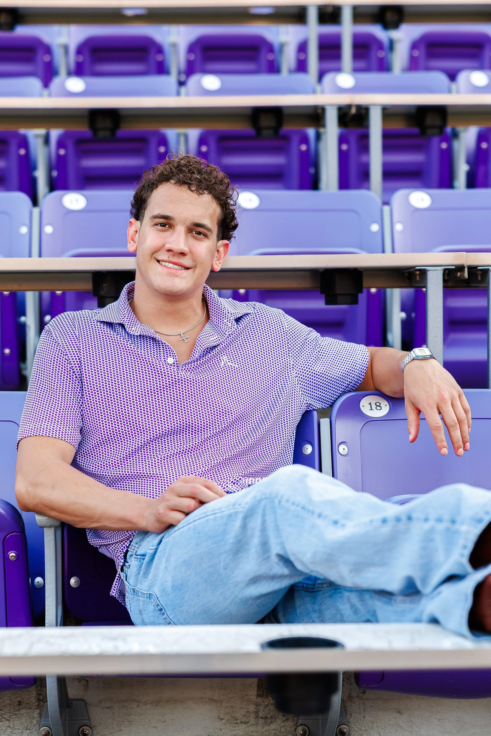 TCU senior guy wearing a purple shirt in the Amon G. Carter football stadium