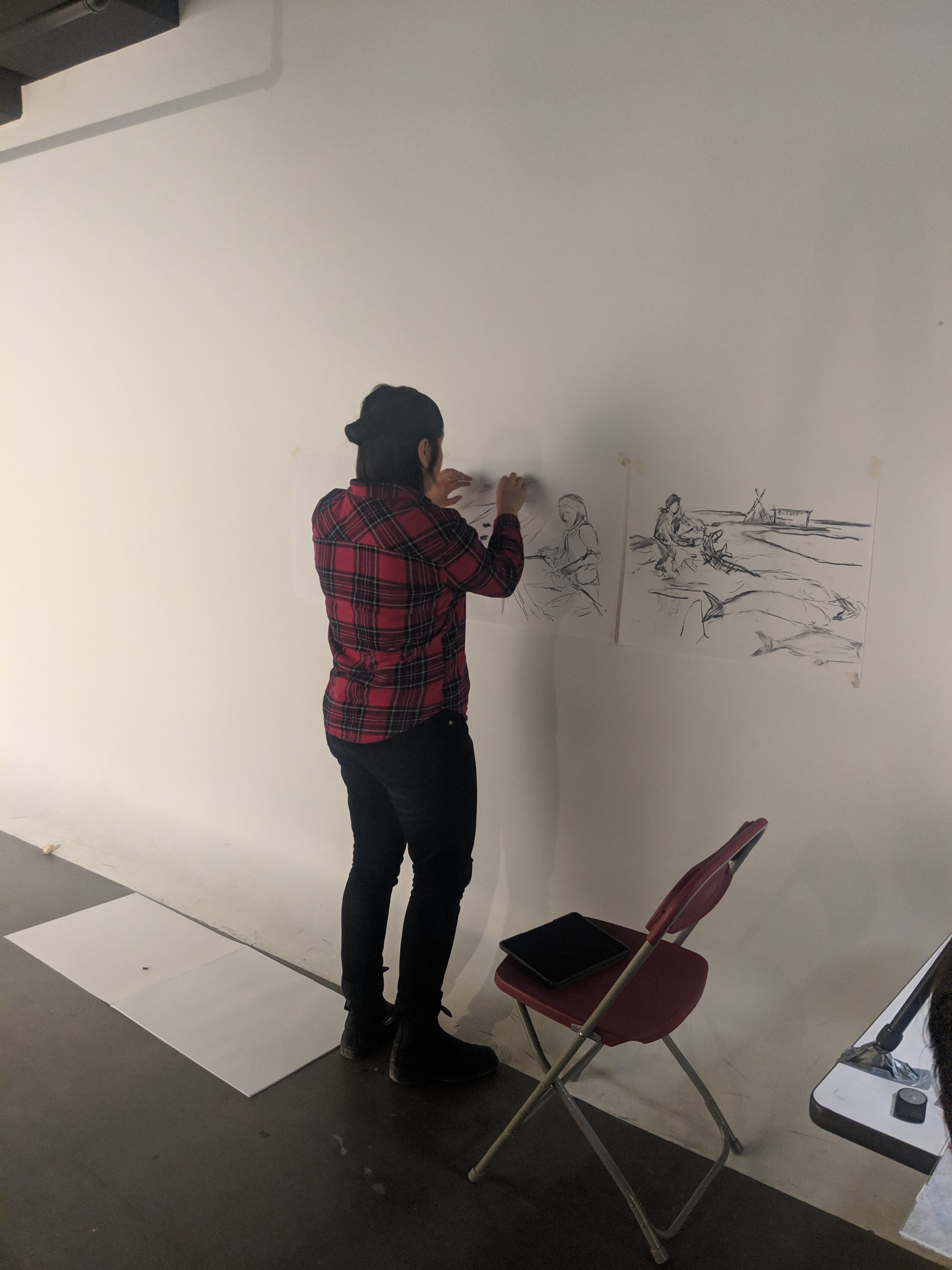  Darcie Bernhardt installs drawings of  Greed Story  (2019), for  Memory Keepers I , Concordia University, Montreal QC, March 2019. Photo by Amanda Shore. 