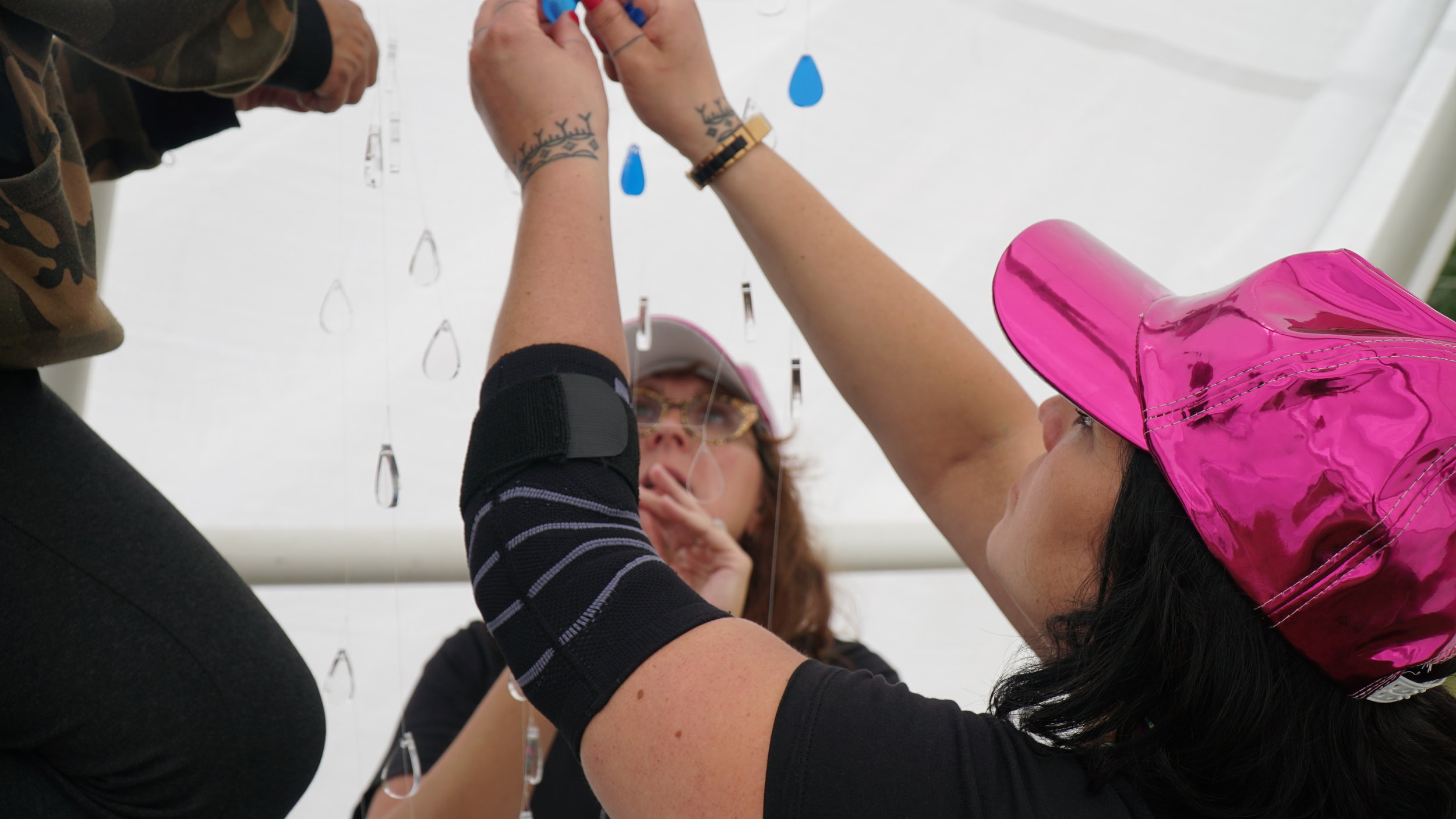  Heather Igloliorte and Carla Taunton installing works for  Memory Keepers II  at Art in the Open, Charlottetown, PEI. August 2019. Photo by Amanda Shore. 