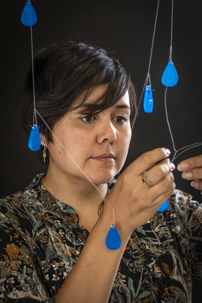  Alberta Rose creating a chandelier in the NSCAD studio using beaded and laser cut droplets, August 2019. Photo by Stephen Brookbank. 