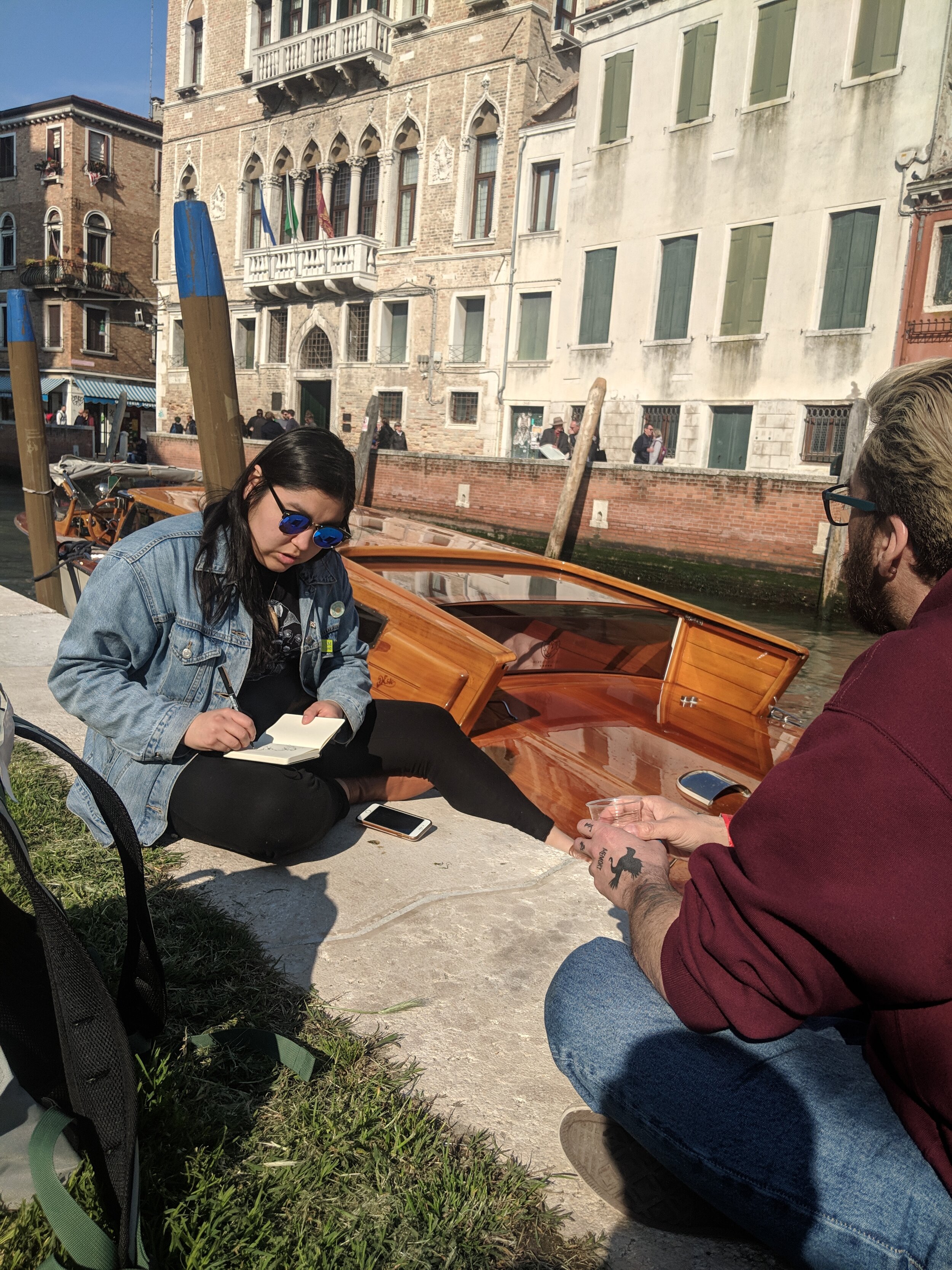  Darcie Bernhardt and Jason Sikoak sketching by the canal in Venice, May 2019. Photo by Amanda Shore. 