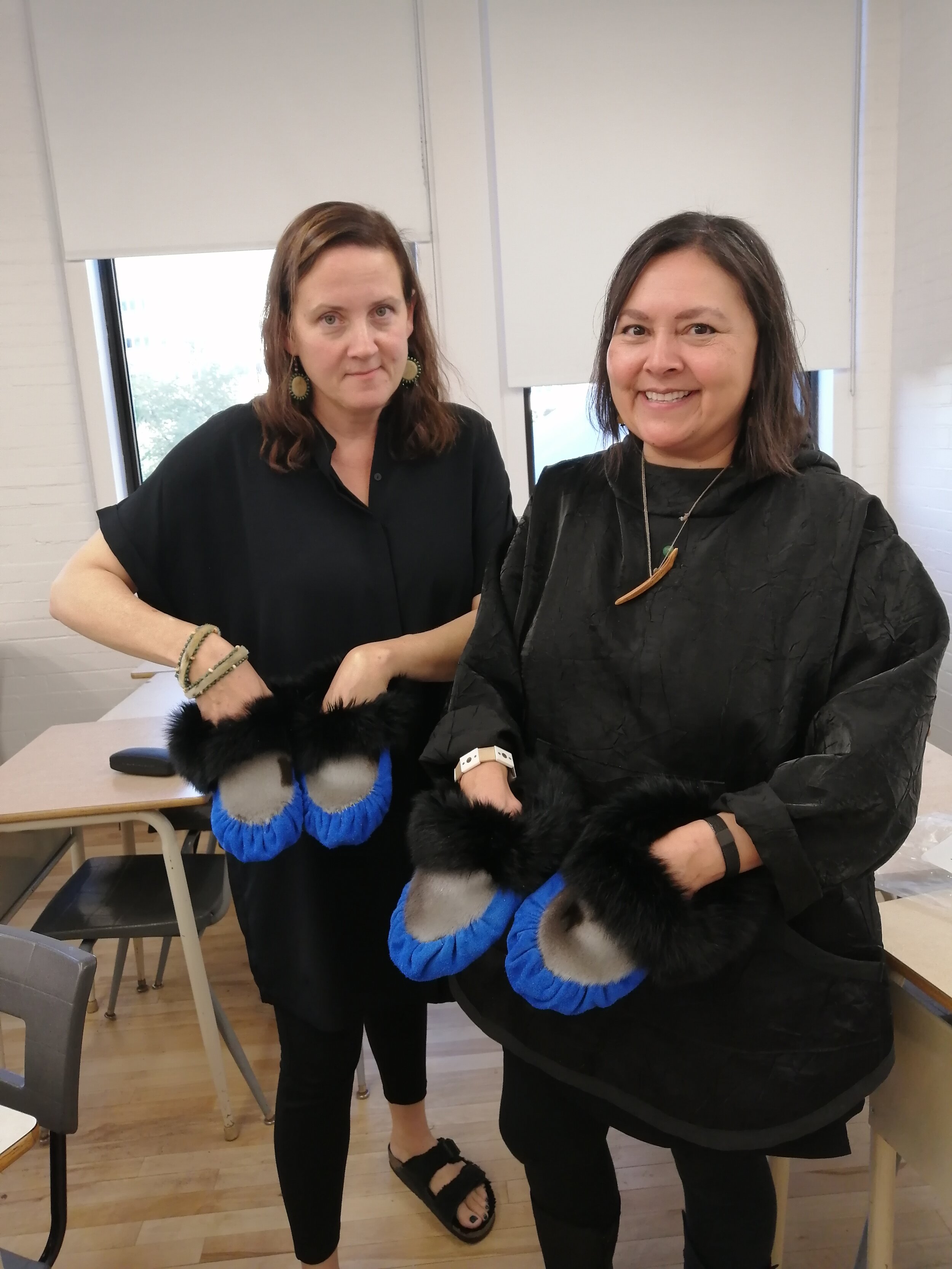  Dawn Biddison (Smithsonian Arctic Studies Center) and artist Sonya Kelliher-Combs with finished slippers made during the Labrador Inuit Slipper Making Workshop, led by Veronica Flowers and Vanessa Flowers, at the 21st Inuit Studies Conference, UQAM,