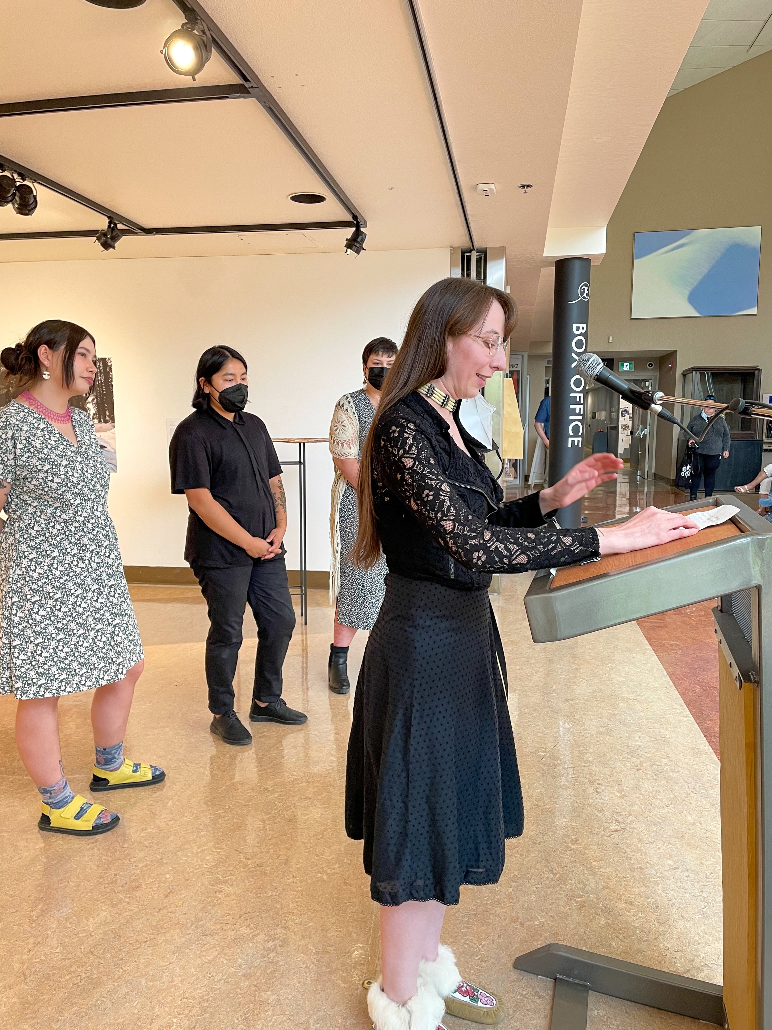  Co-curator Teresa Vander Meer-Chassé speaking at the opening of  TETHER , Yukon Arts Centre, Whitehorse, YK, July 2022. Photo courtesy of Yukon Arts Centre. 